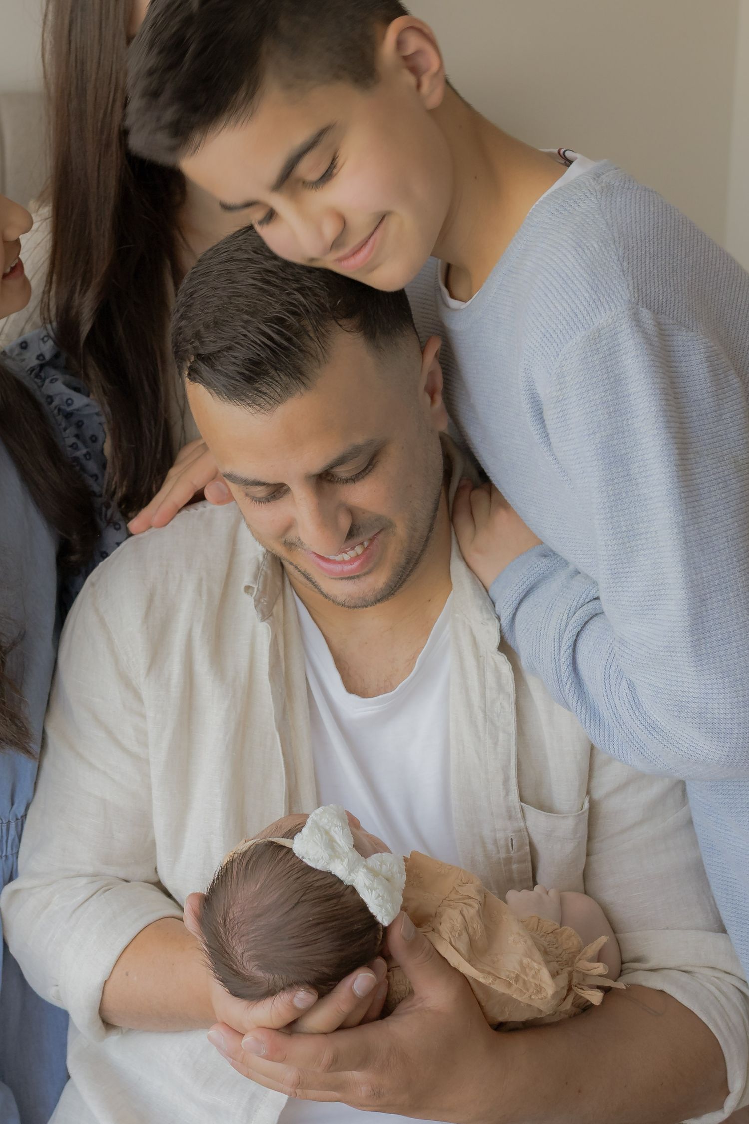 Newborn session, Father holding newborn daughter, son hugging dad and smiling, Family connection Point Cook, Melbourne Victoria