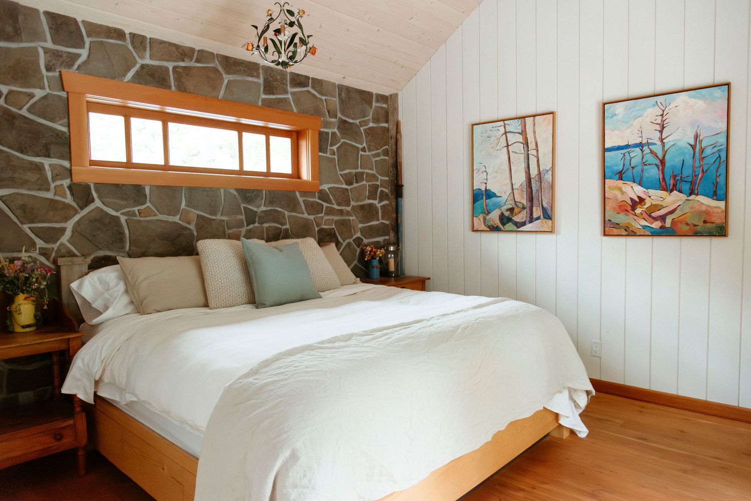 king sized bed and stone wall in the wild plum cottage