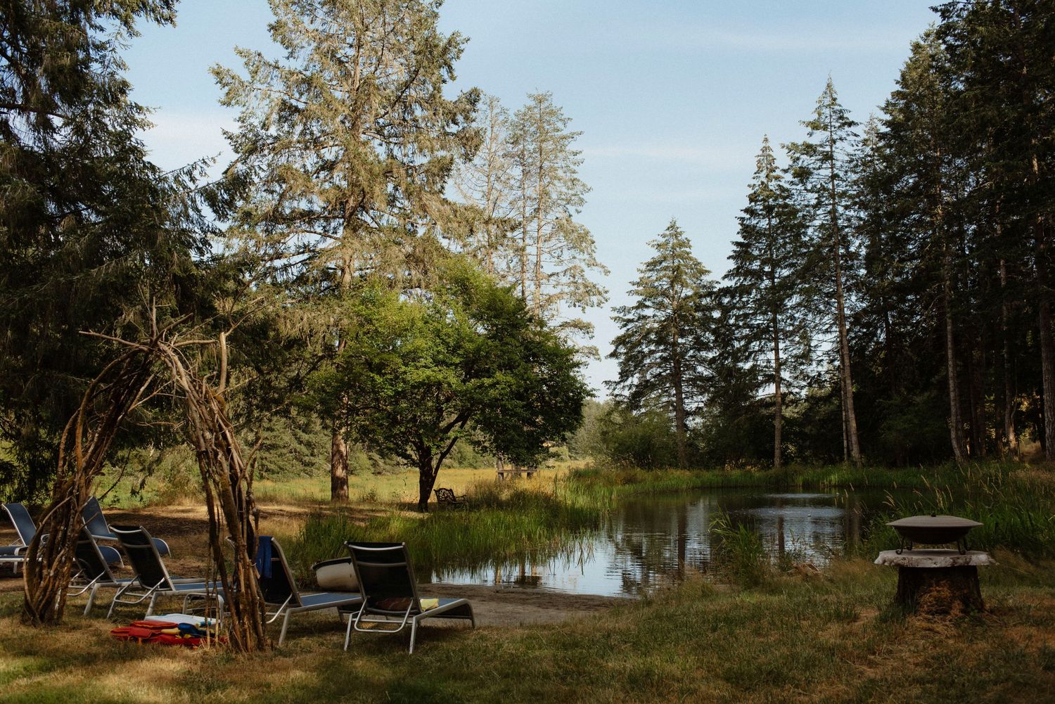 pond beach front and beach chairs at sacred arrow estates