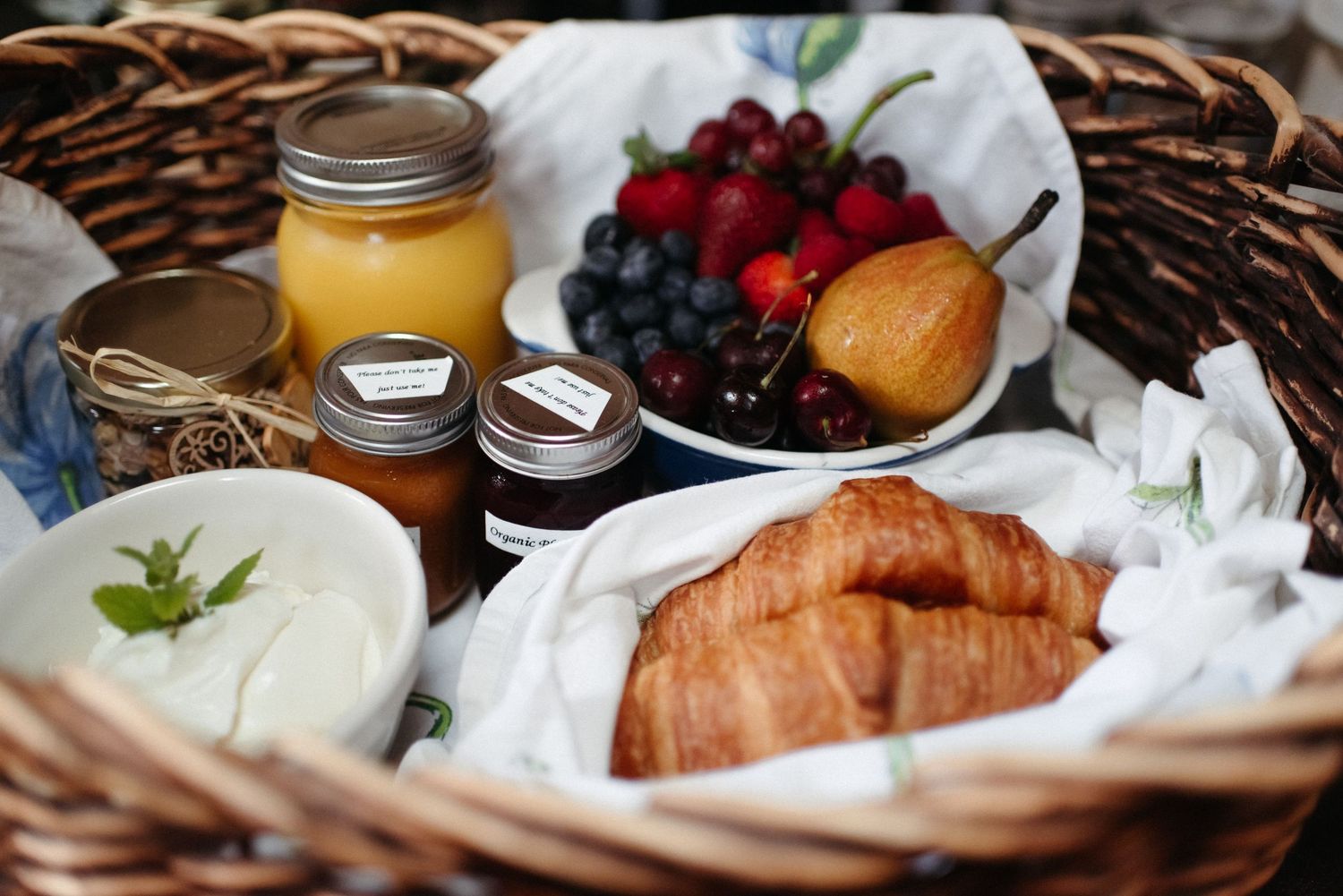 breakfast foods, fruit, croissants, yogurt and juice