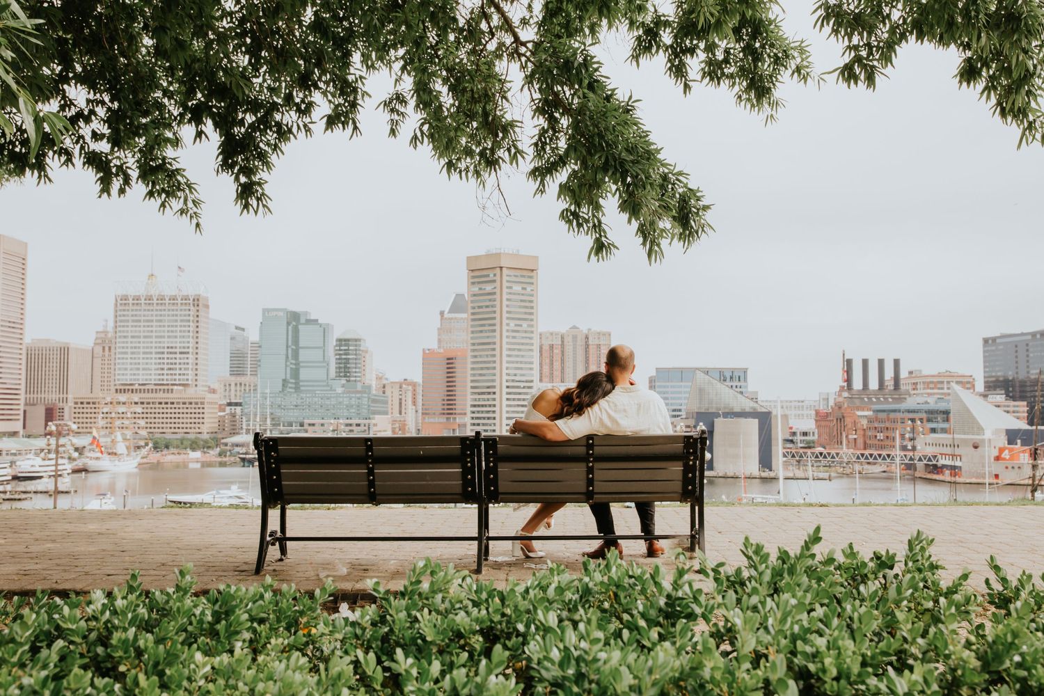 Couple sitting on bench at Federal Hill Park in Baltimore, Maryland - engagement photography