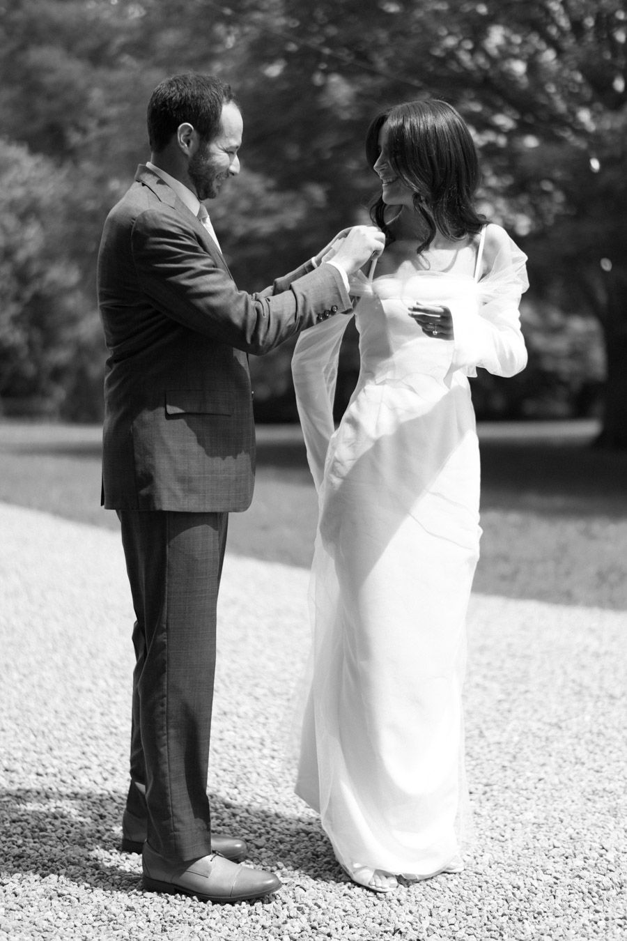 Couple shares intimate moment during wedding ceremony in elegant outdoor setting.