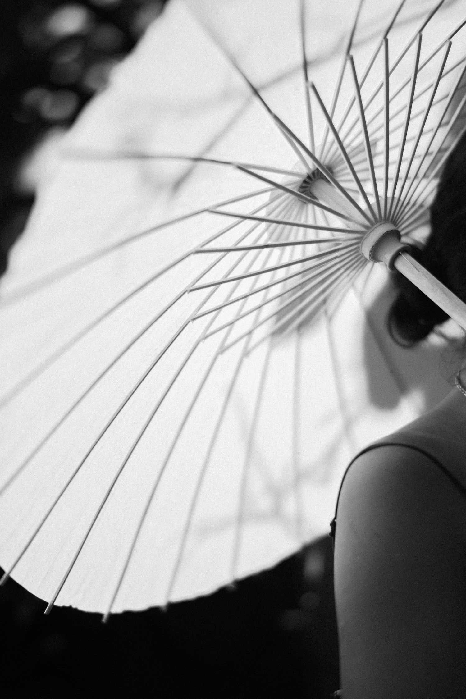 A sequence of black and white photographs showing different angles and details of a traditional paper parasol.