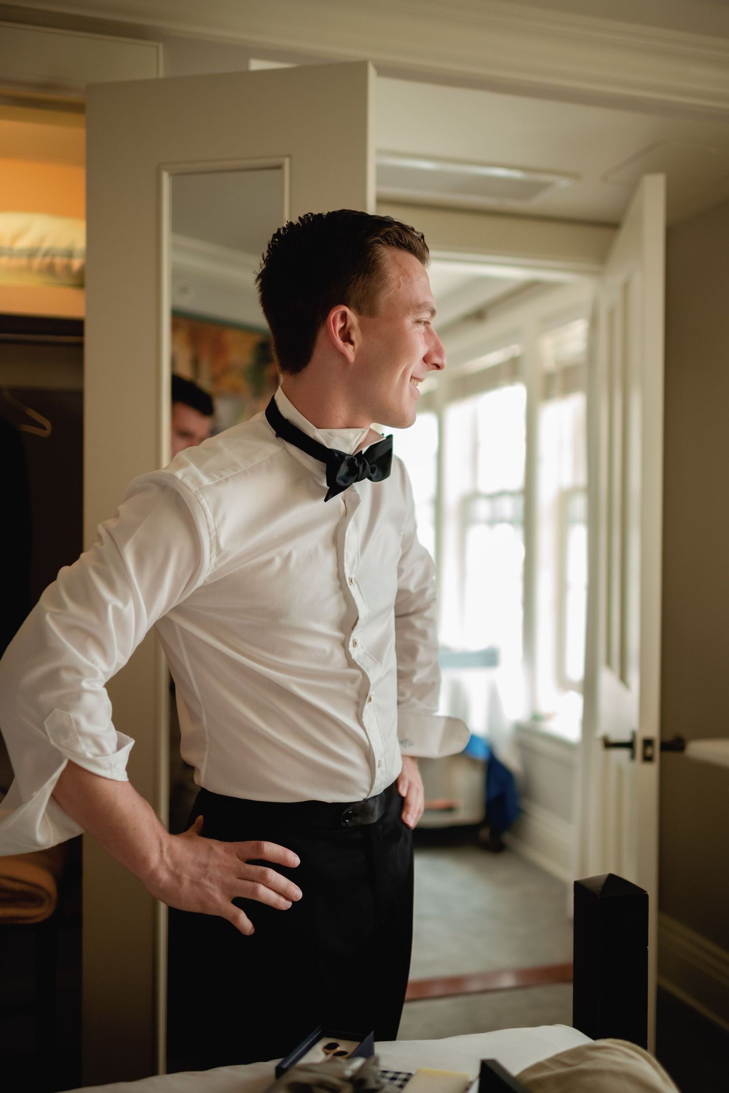 A series of images showing a server in formal attire adjusting their back while working in a restaurant setting.