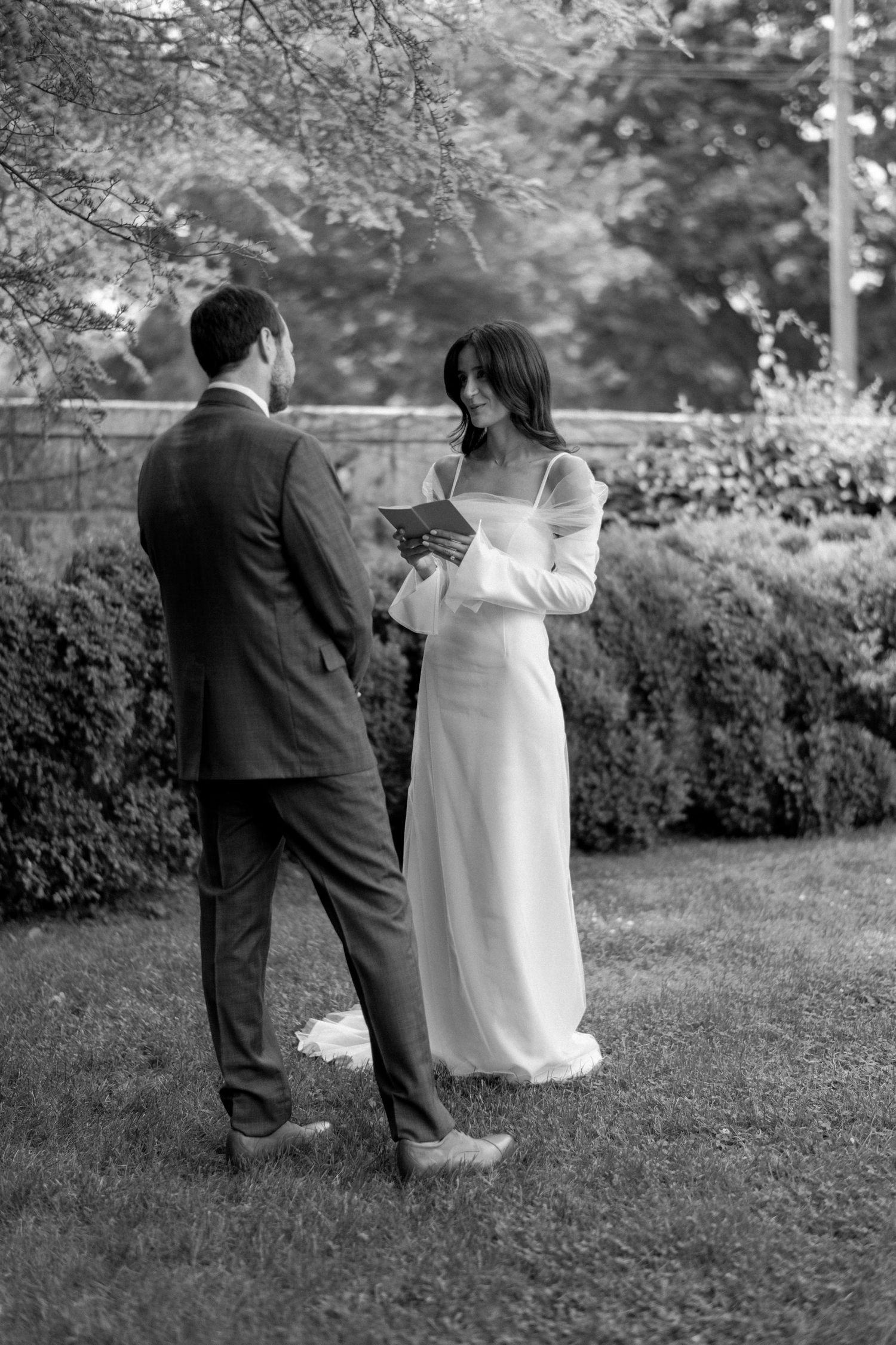Intimate outdoor wedding ceremony moment with couple exchanging vows.