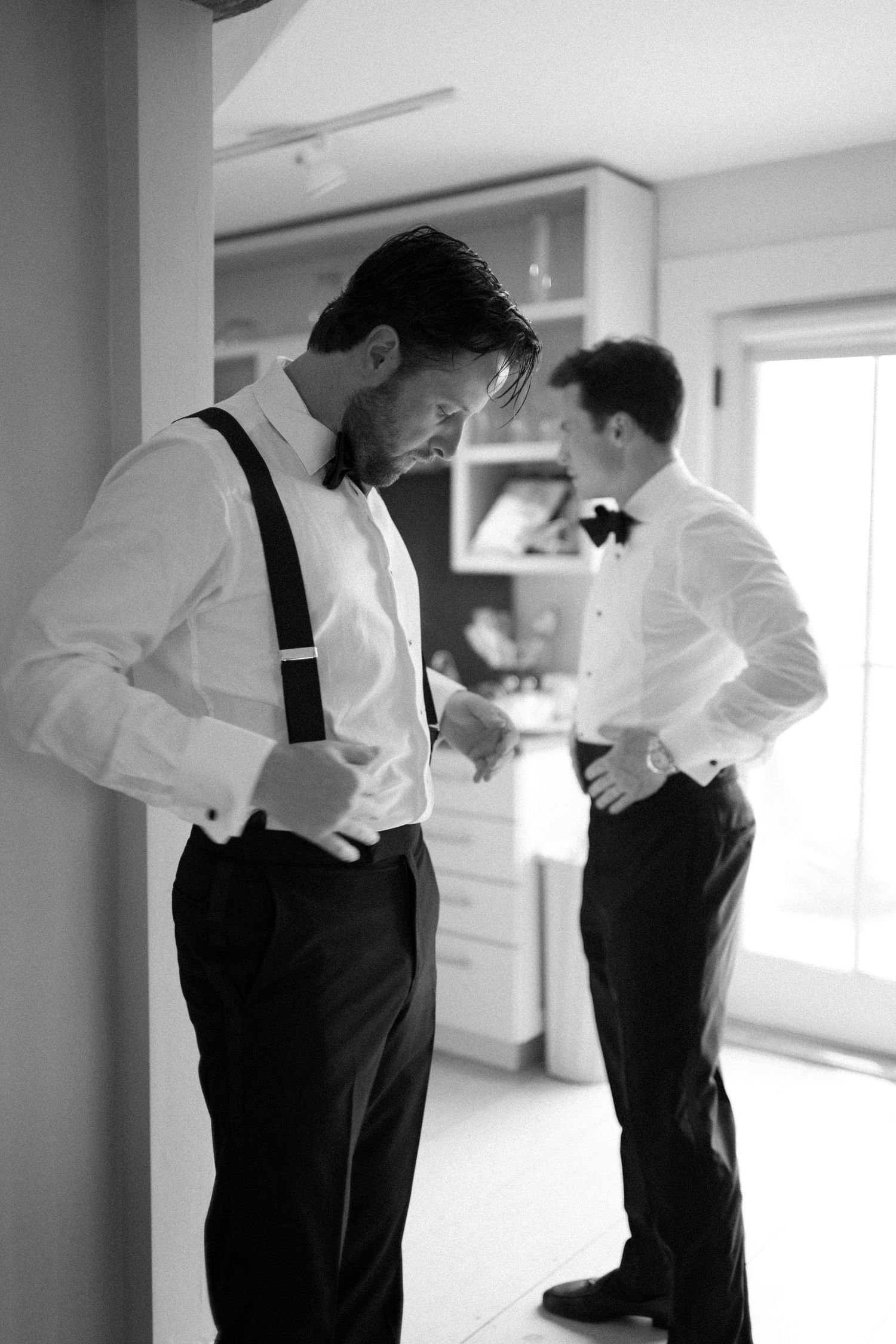 A sequence of black and white photos showing two people in formal attire interacting in an office setting.