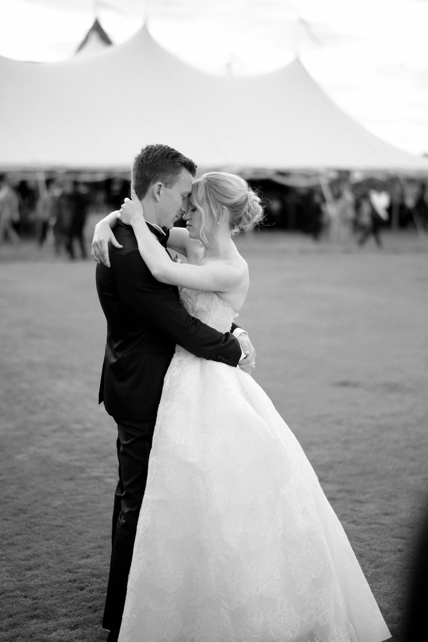 A romantic black and white wedding photo series showing a couple embracing in an outdoor setting.