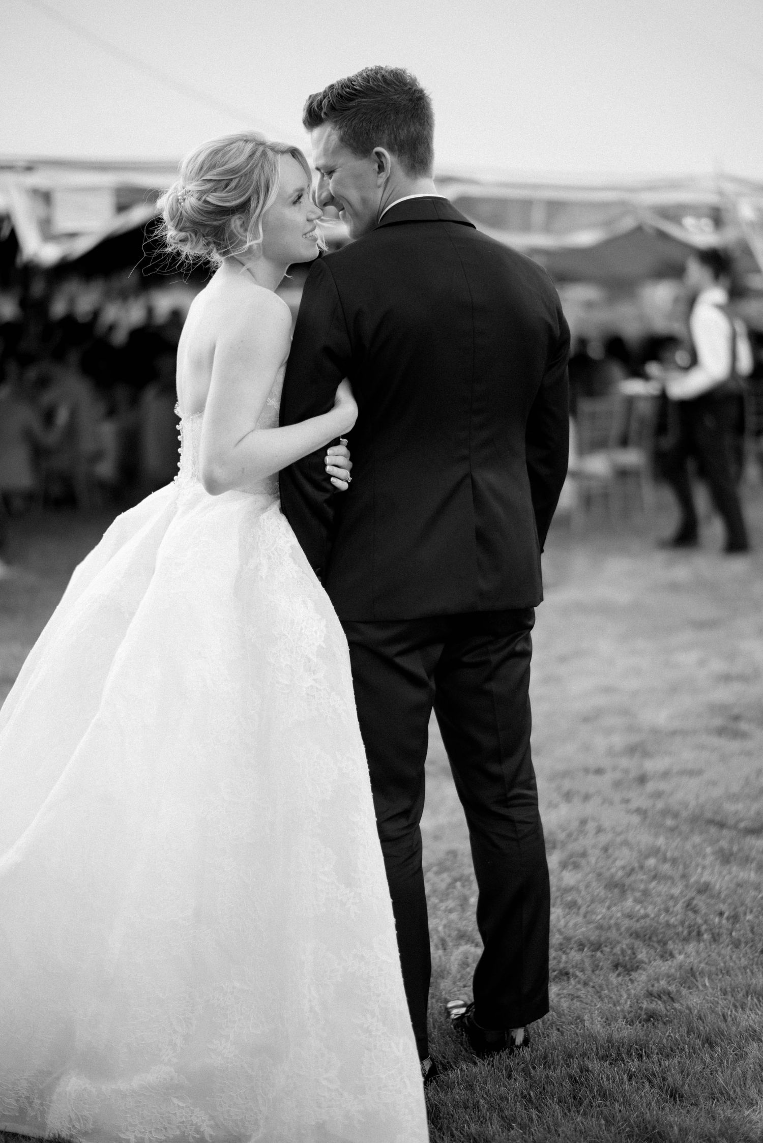 A romantic sequence of black and white wedding photos showing a bride and groom together in an outdoor setting.