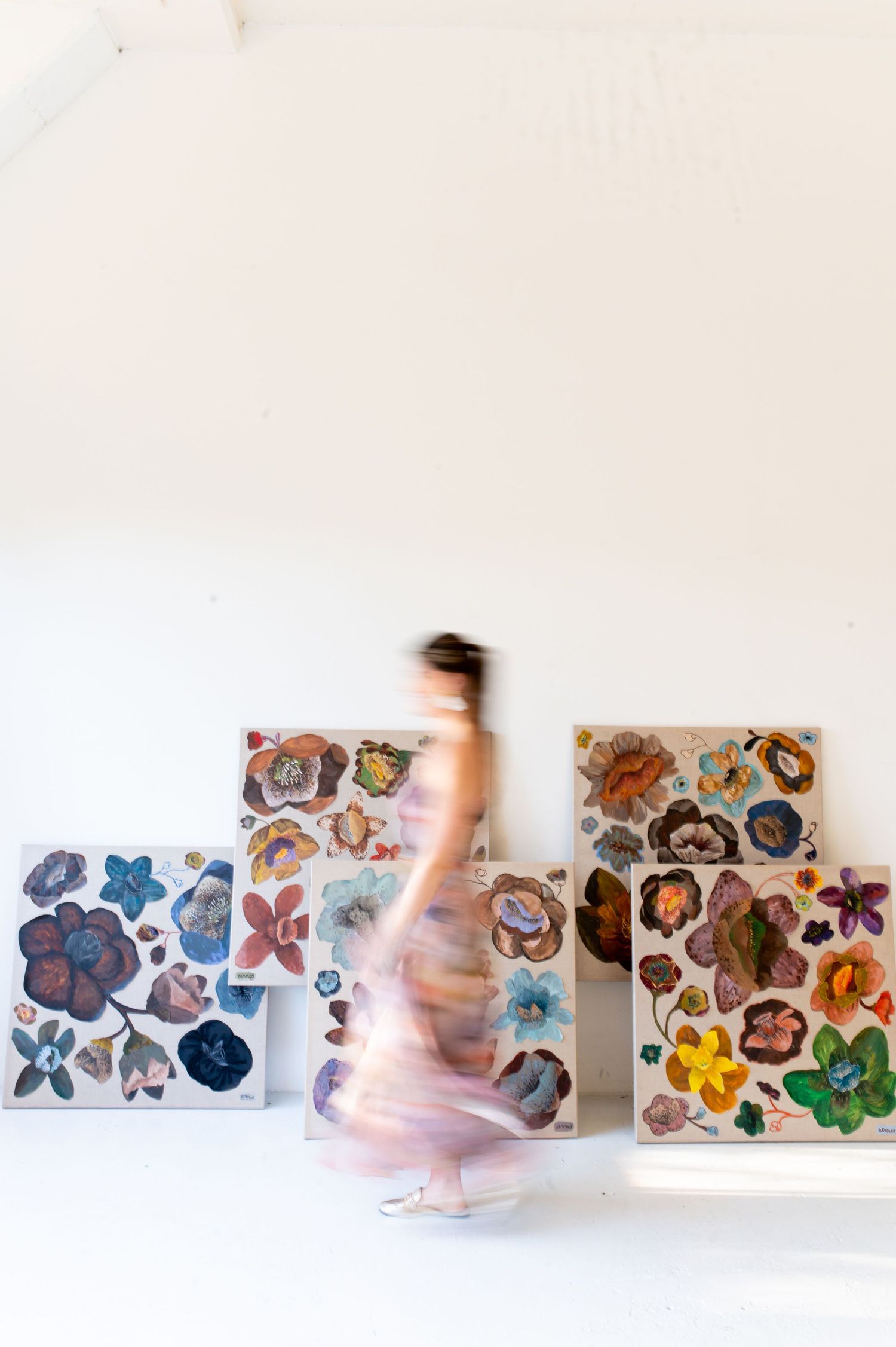 Abstract watercolor paintings of flowers displayed in sequence with motion blur effect.