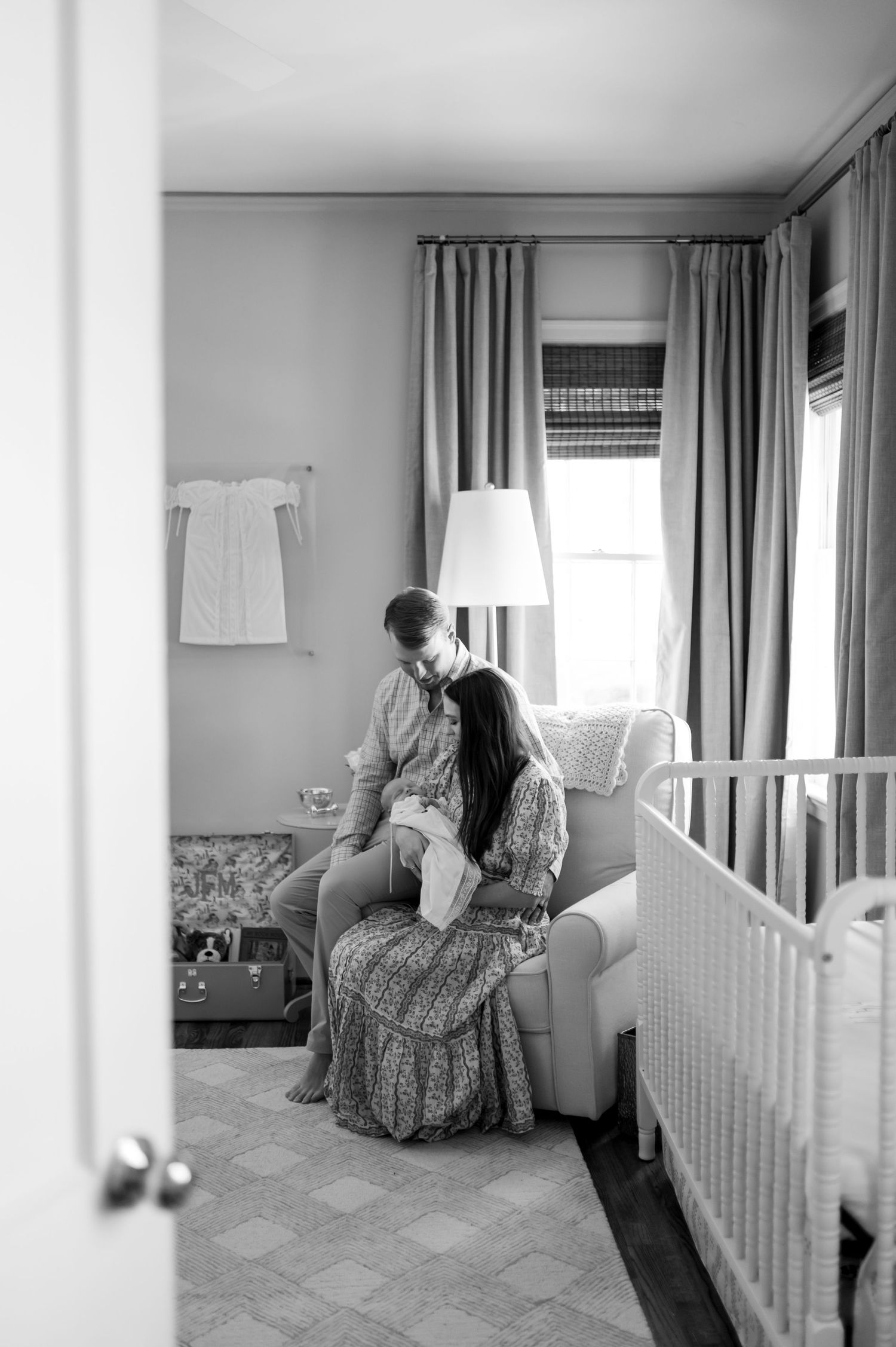 Black and white photo series showing a quiet moment in a bright bedroom with curtained windows and a floral armchair.