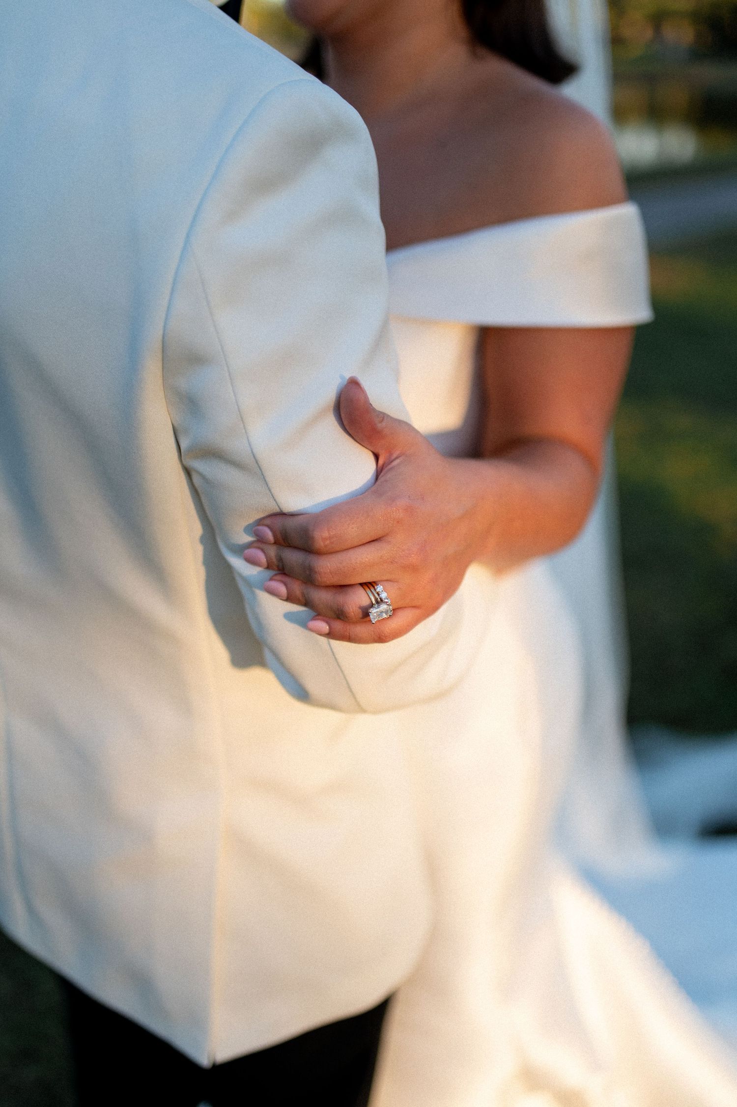 Close-up details of white wedding dress fabric and styling.