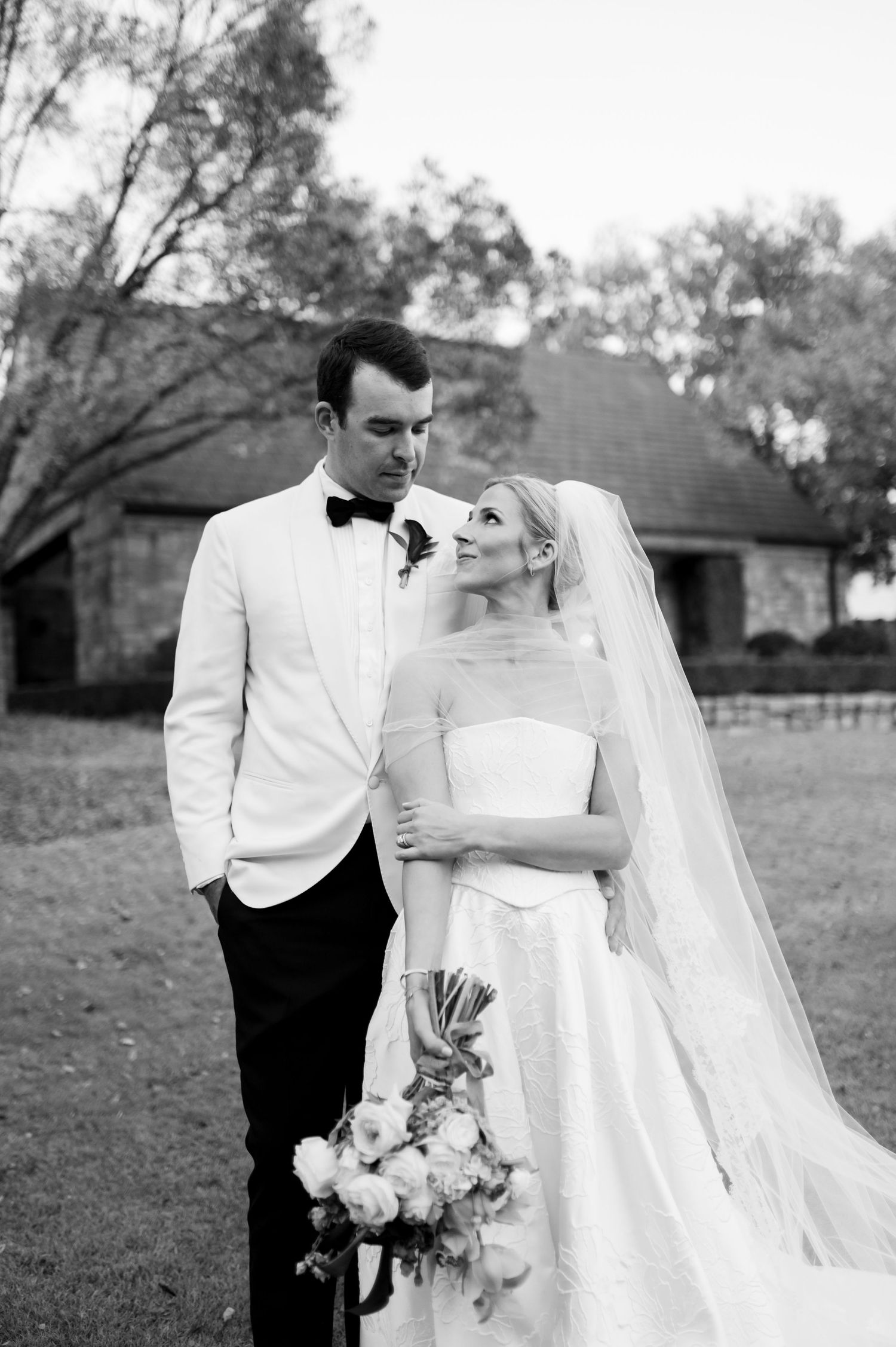 Elegant black and white wedding portraits showing intimate moments between the bride and groom.