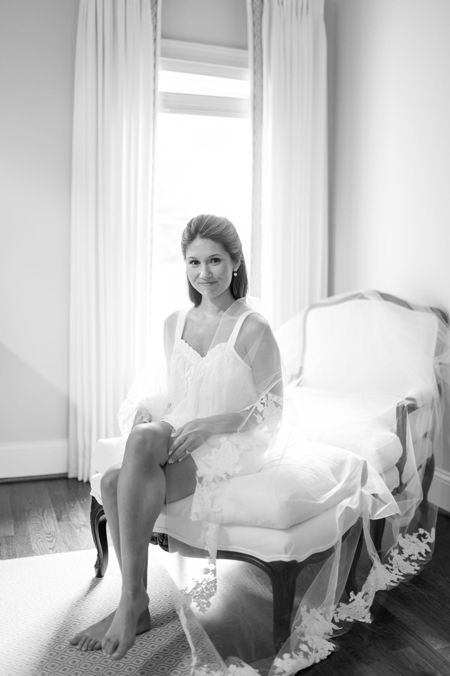 Bright white room with elegant curtains and wedding dress details.