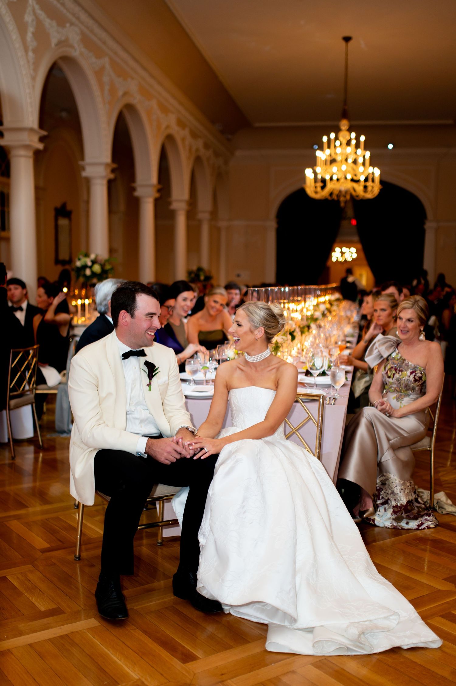 Wedding dance sequence showing romantic moments under crystal chandeliers in a grand ballroom.