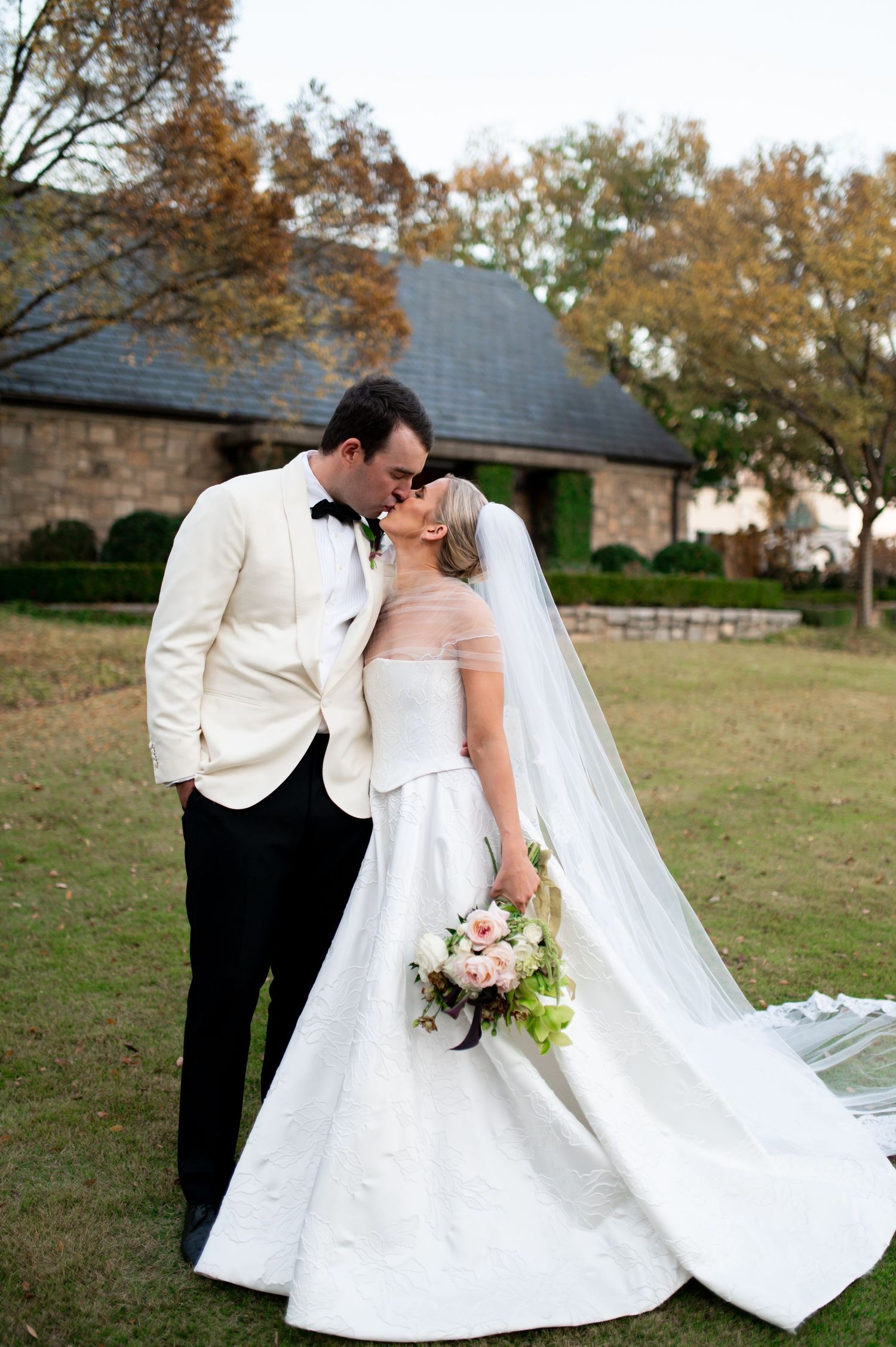Romantic wedding portraits featuring elegant white dress against rustic outdoor setting.