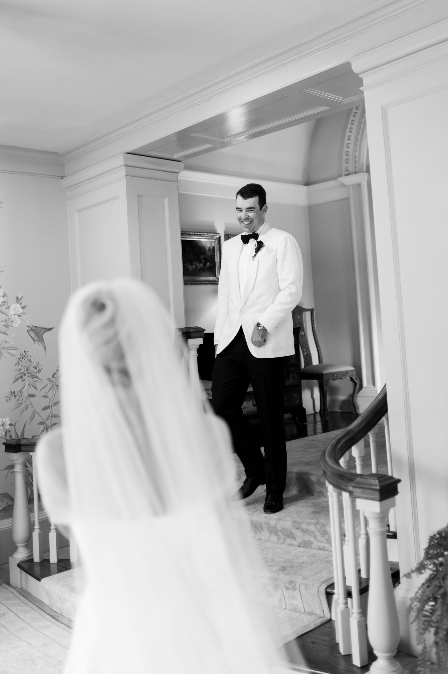 A series of black and white photos showing ghostly movement in an elegant interior hallway.