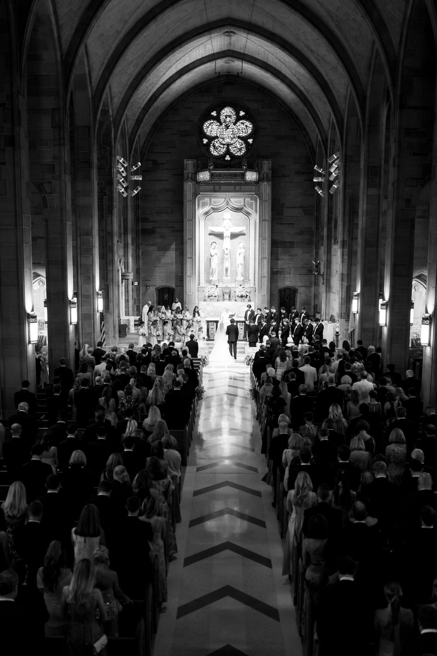 Church ceremony in a grand gothic cathedral with vaulted ceilings and dramatic lighting.