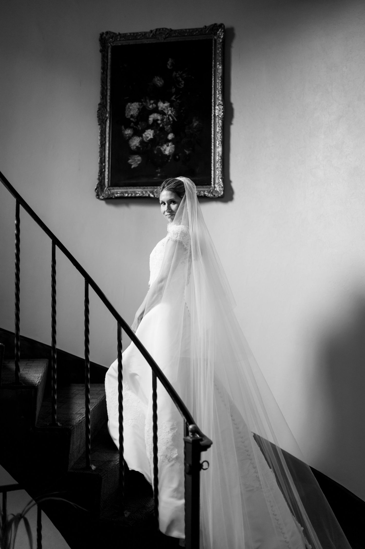 Black and white series showing wedding dress details near a vintage staircase.