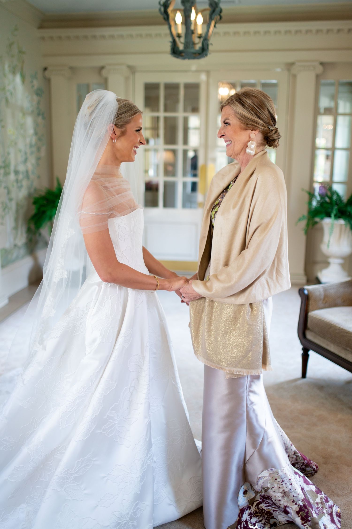 Wedding dress fitting moments captured in an elegant white interior room.