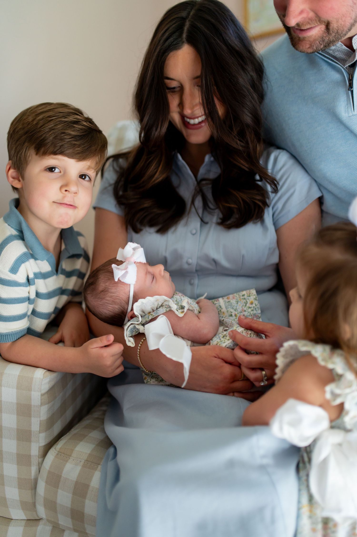 A series of three photos showing a family meeting their newborn baby in a cozy home setting.