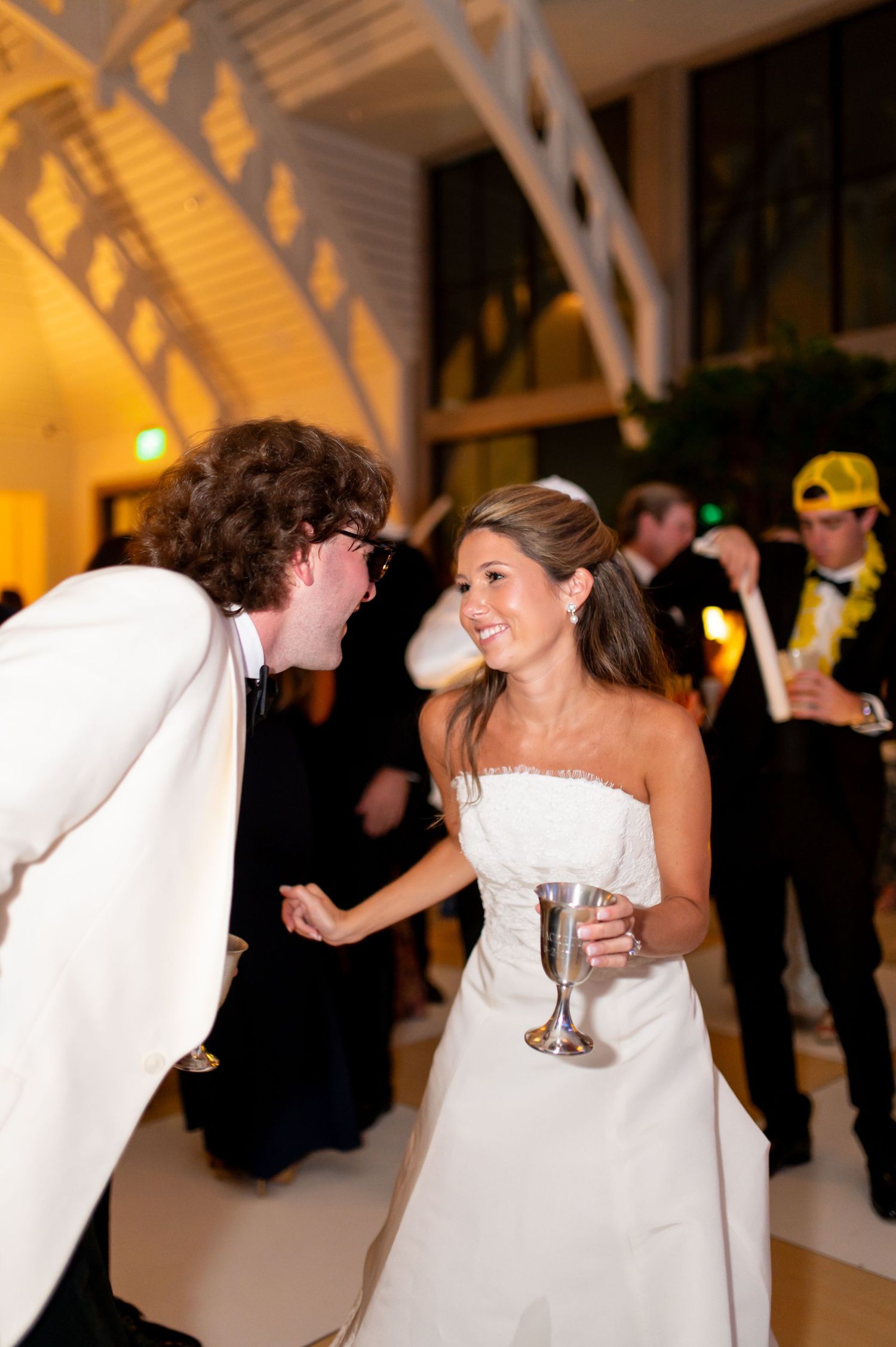 A candid moment of laughter and dancing during the wedding reception.