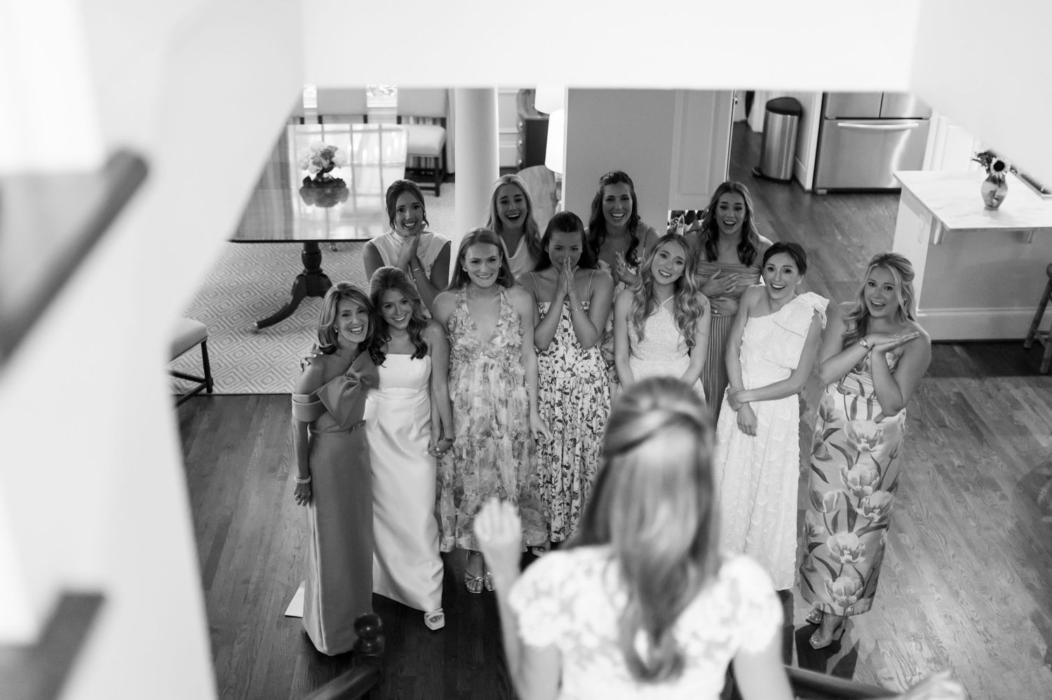 Wedding party celebrating in indoor venue with natural light.