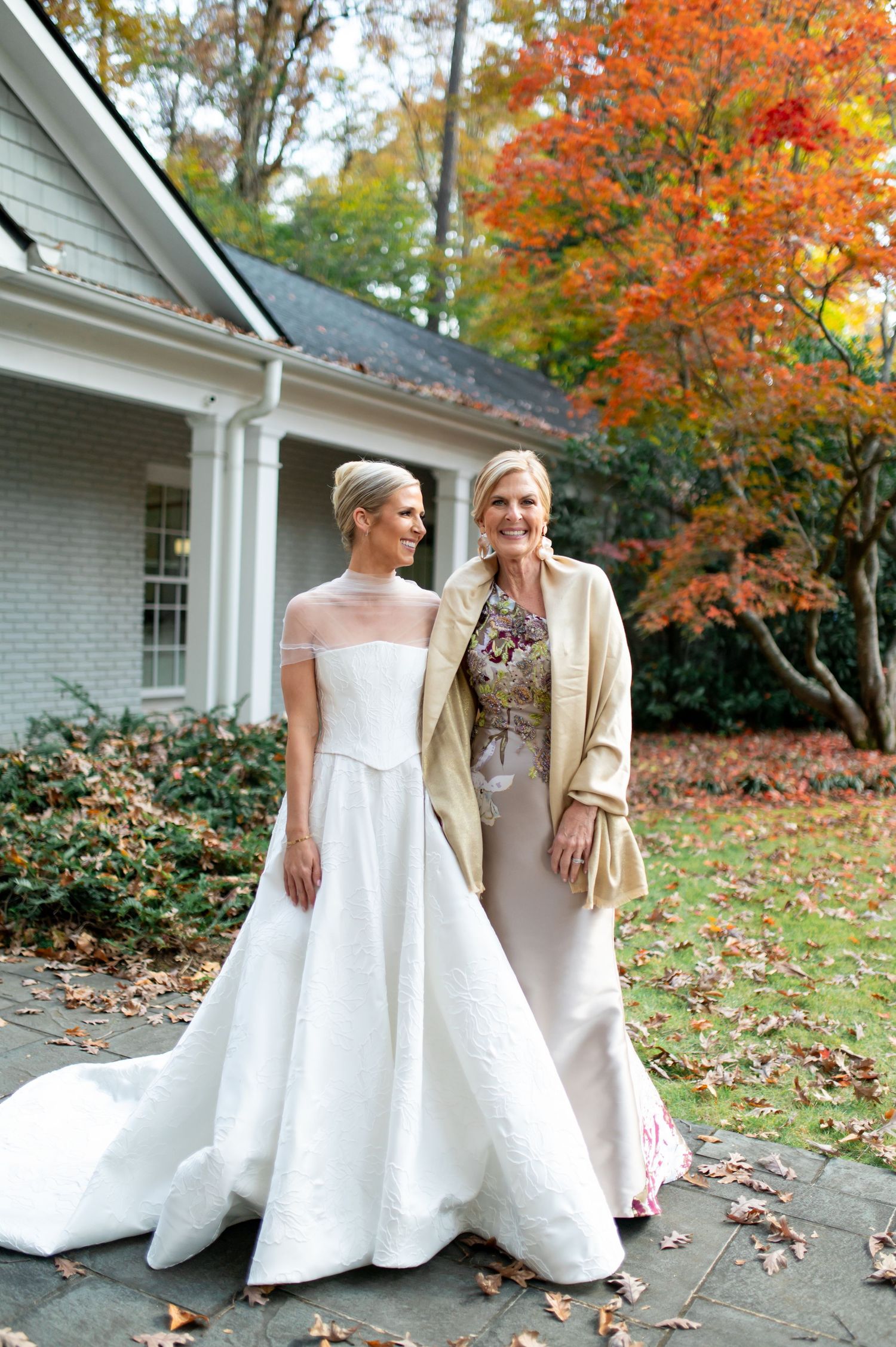 Elegant wedding portrait with beautiful fall foliage backdrop.