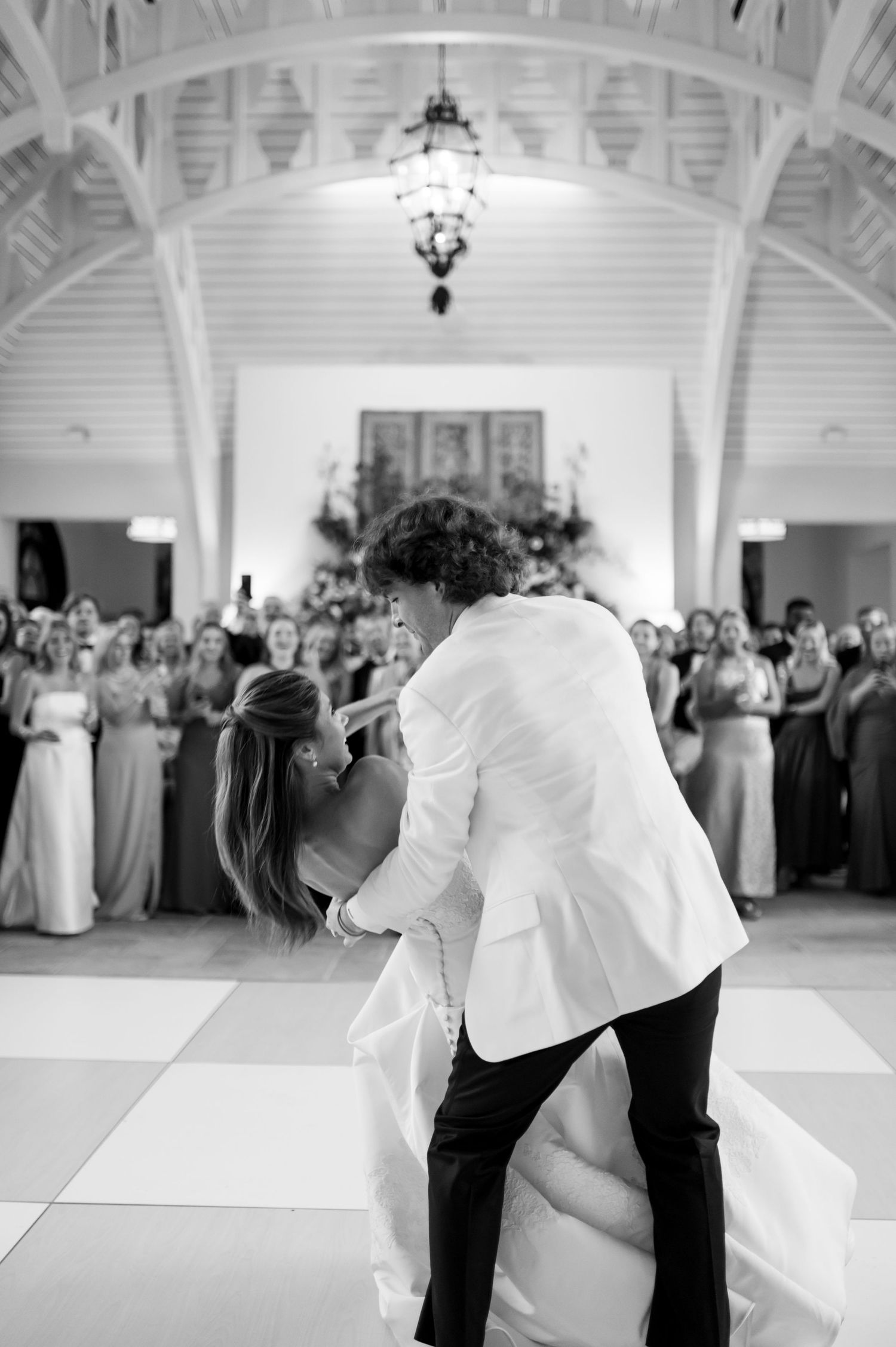 A dramatic dip during the wedding dance beneath a beautiful vaulted ceiling.