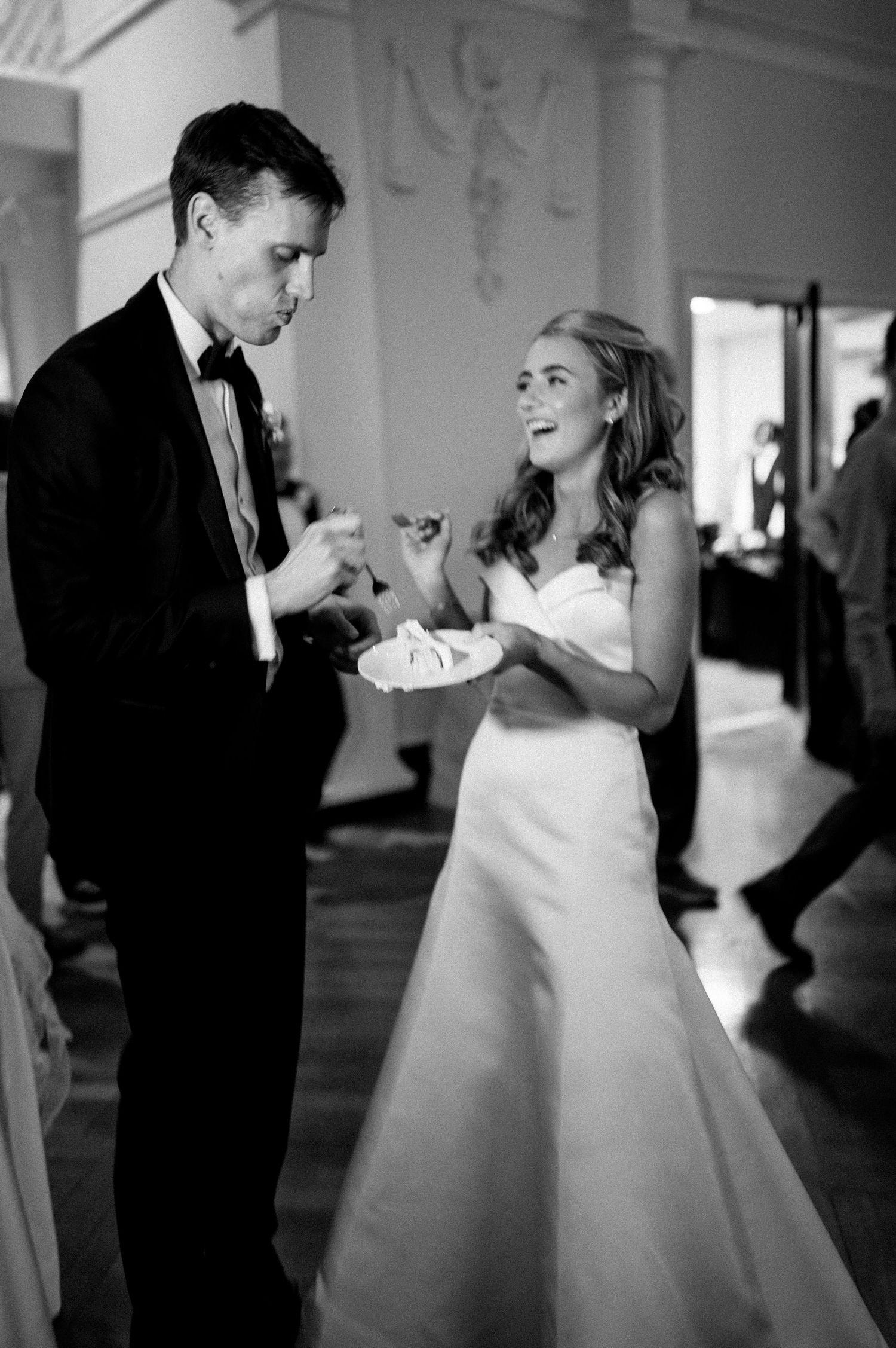 Couple dancing in black and white at an elegant wedding reception.
