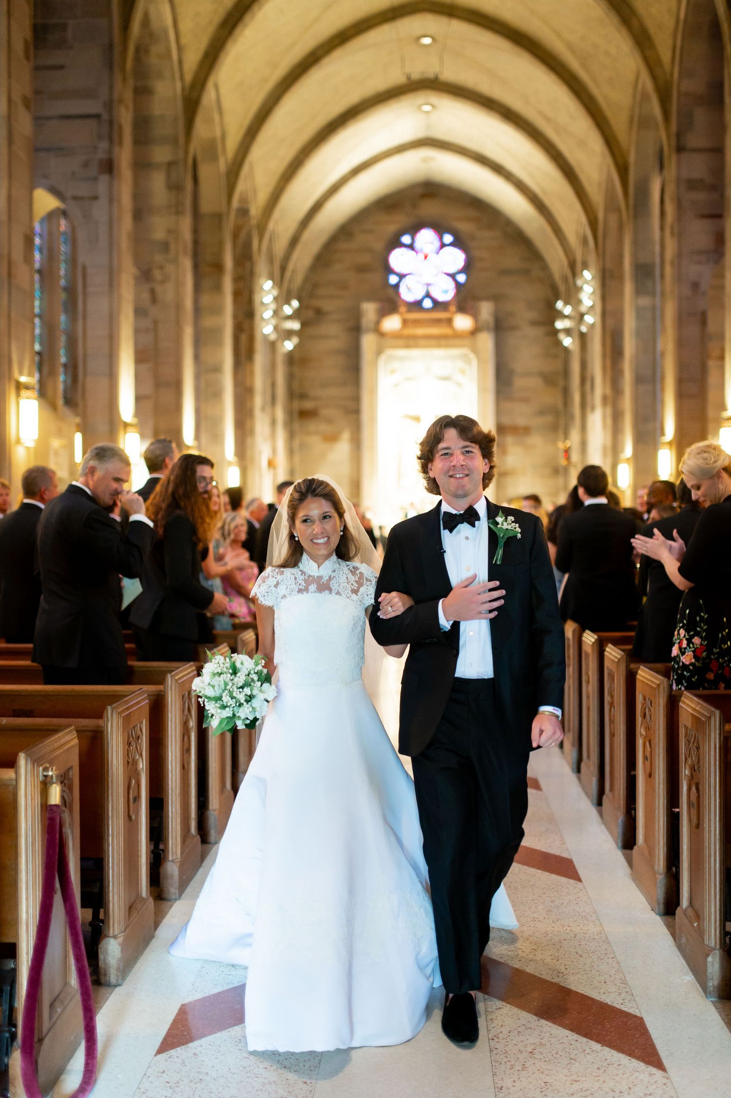 Wedding celebration in a gothic cathedral with arched ceilings and stone columns.