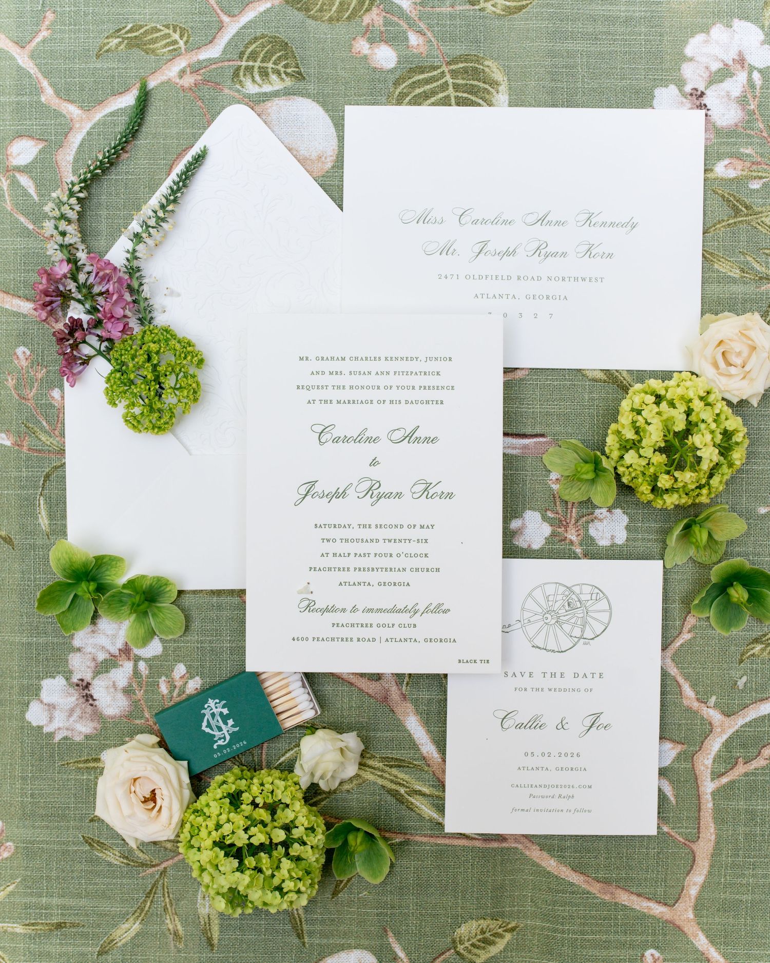 Elegant wedding invitation suite with green floral accents on a sage green botanical background.