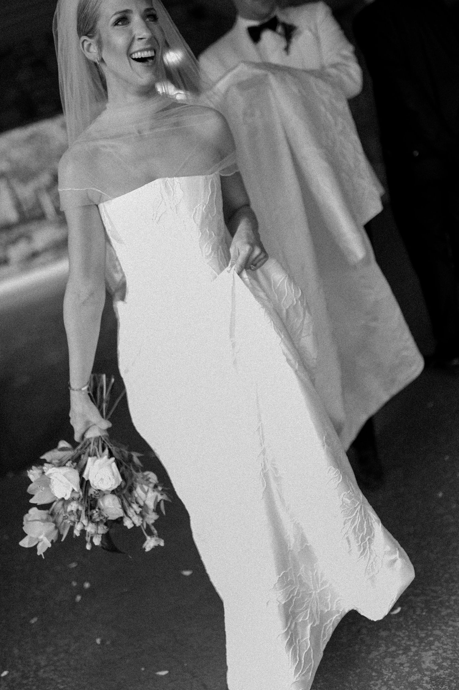 Black and white series of a bride's dress in motion during a wedding photoshoot.
