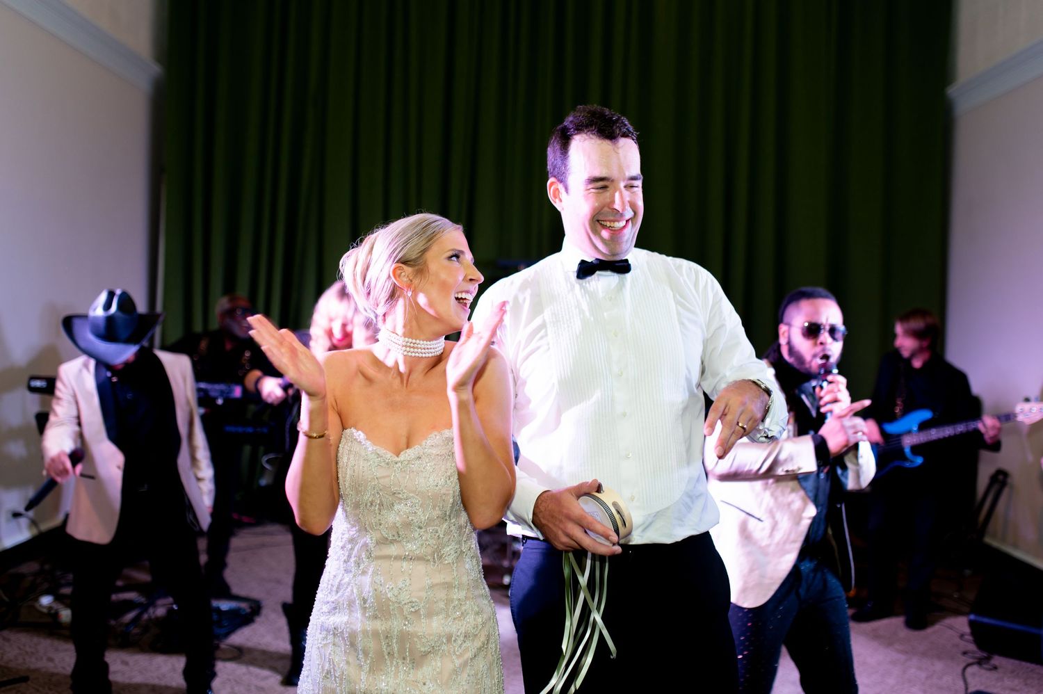 Wedding reception dance party with guests holding light-up wands.