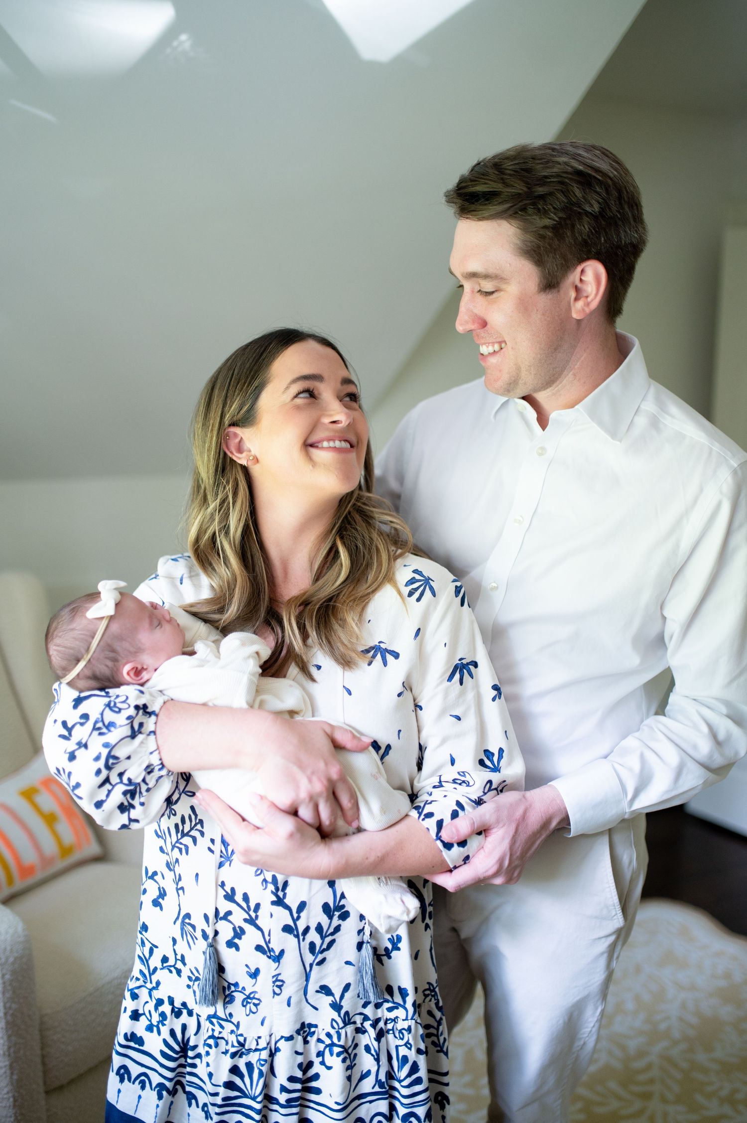Intimate family moments on white furniture wearing coordinating blue and white outfits.