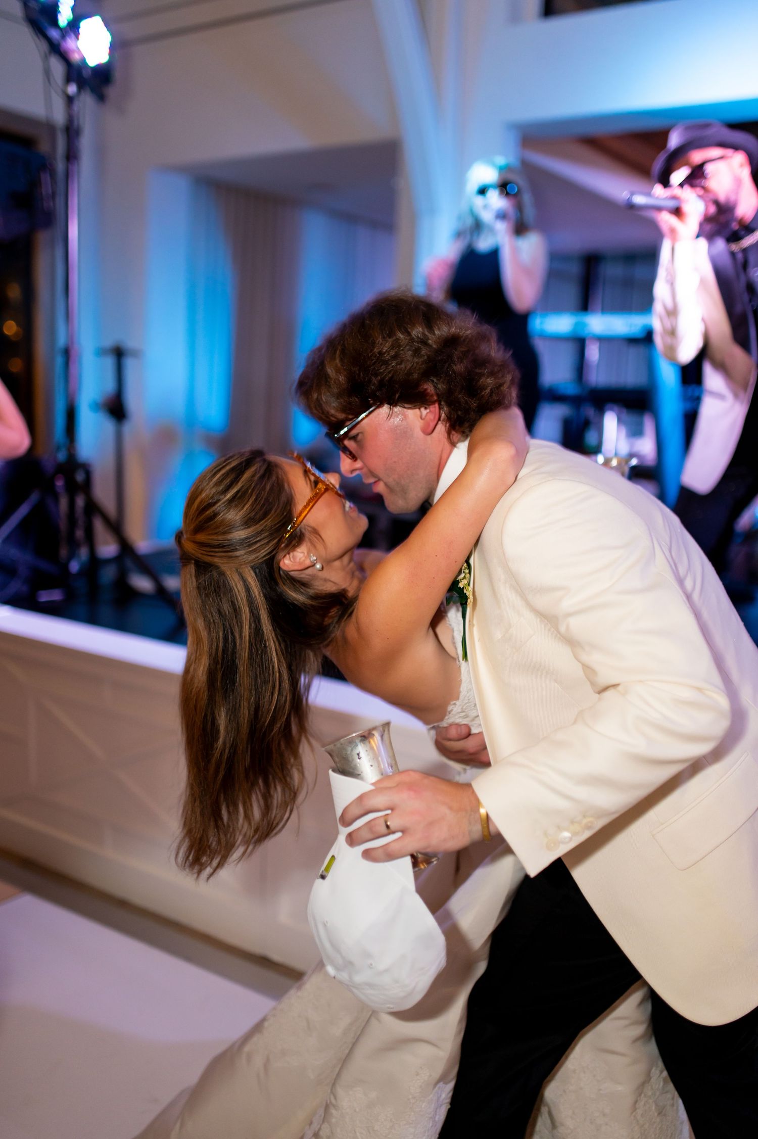 Romantic dance sequence showing a couple in formal attire dipping and embracing at a wedding reception.