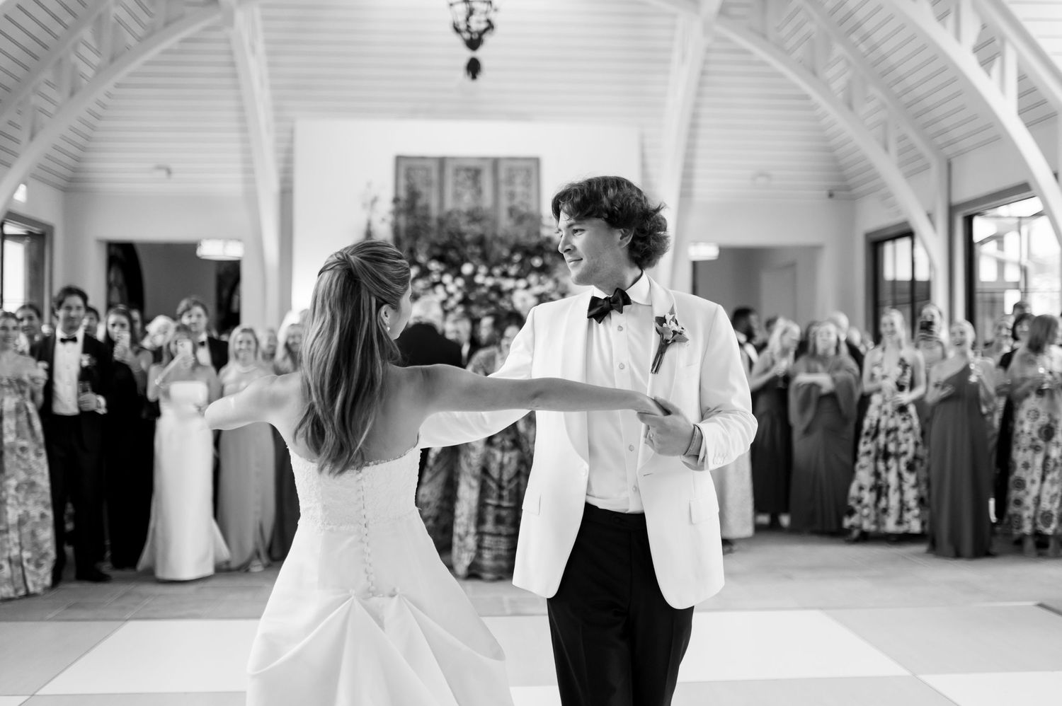 A romantic dance moment captured in black and white during a wedding reception.