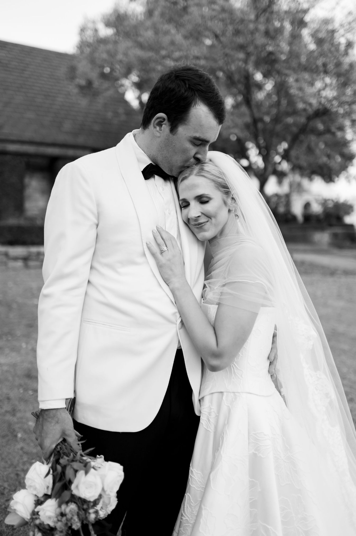 Black and white romantic wedding portraits showing tender moments between newlyweds.