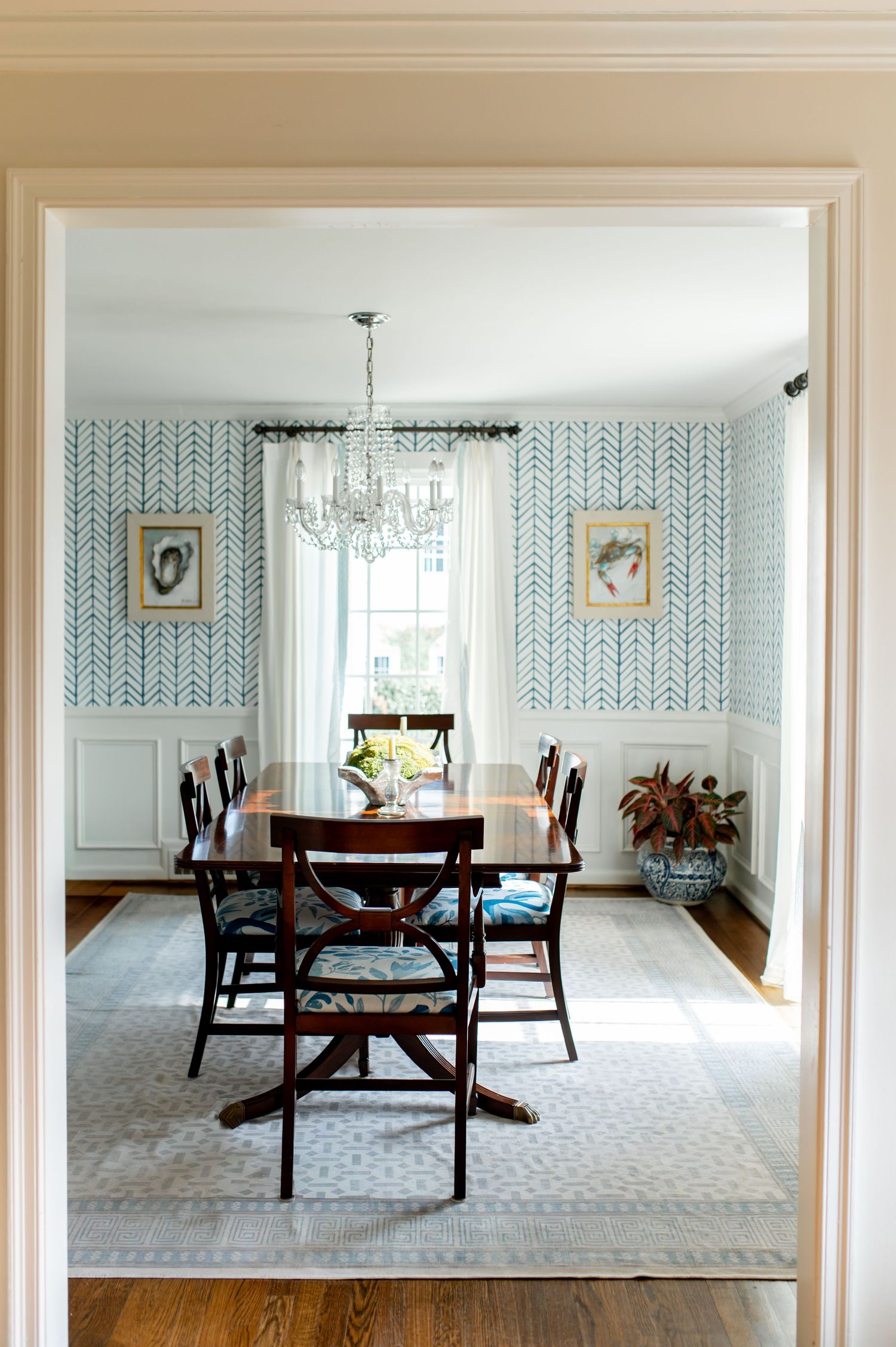 Elegant dining room with blue wallpaper, dark wood furniture, and white carpet shown from multiple angles in progression.