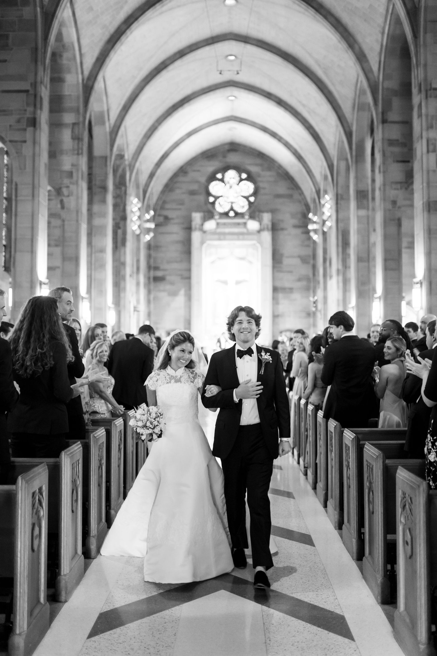 Wedding procession down cathedral aisle with vaulted ceilings and natural light.