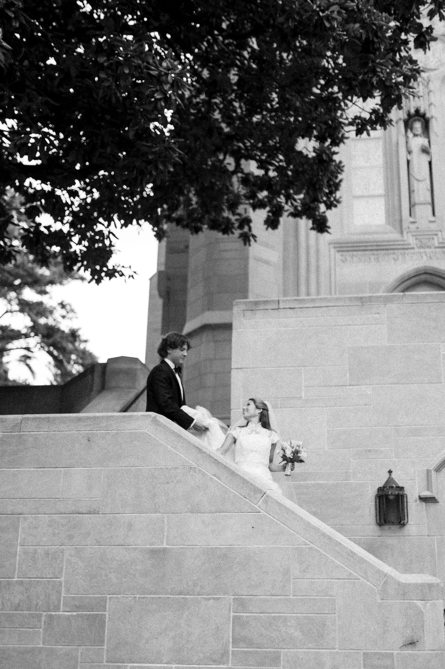 Wedding photography sequence showing couple descending stone church steps.