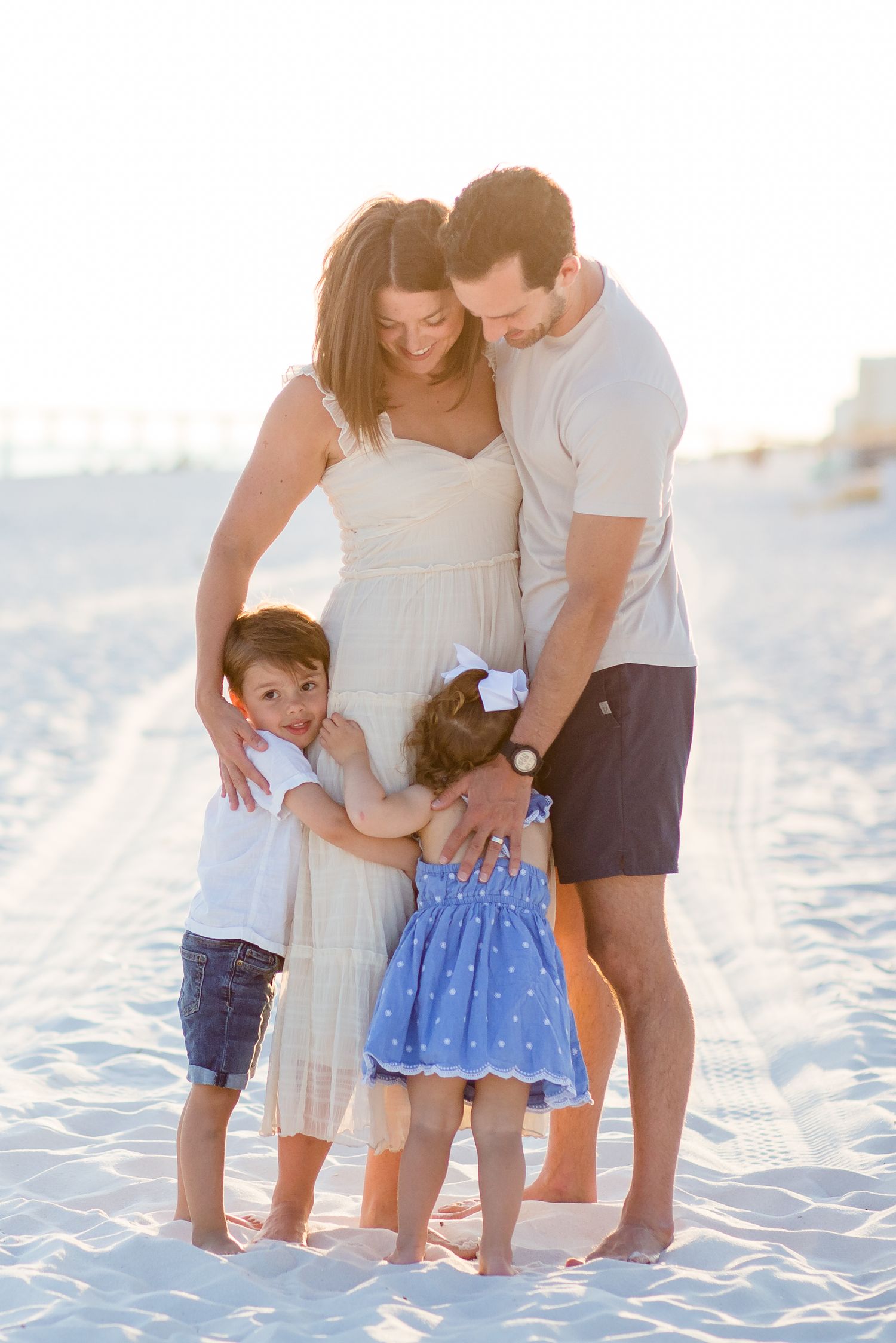 family hugs on the beach