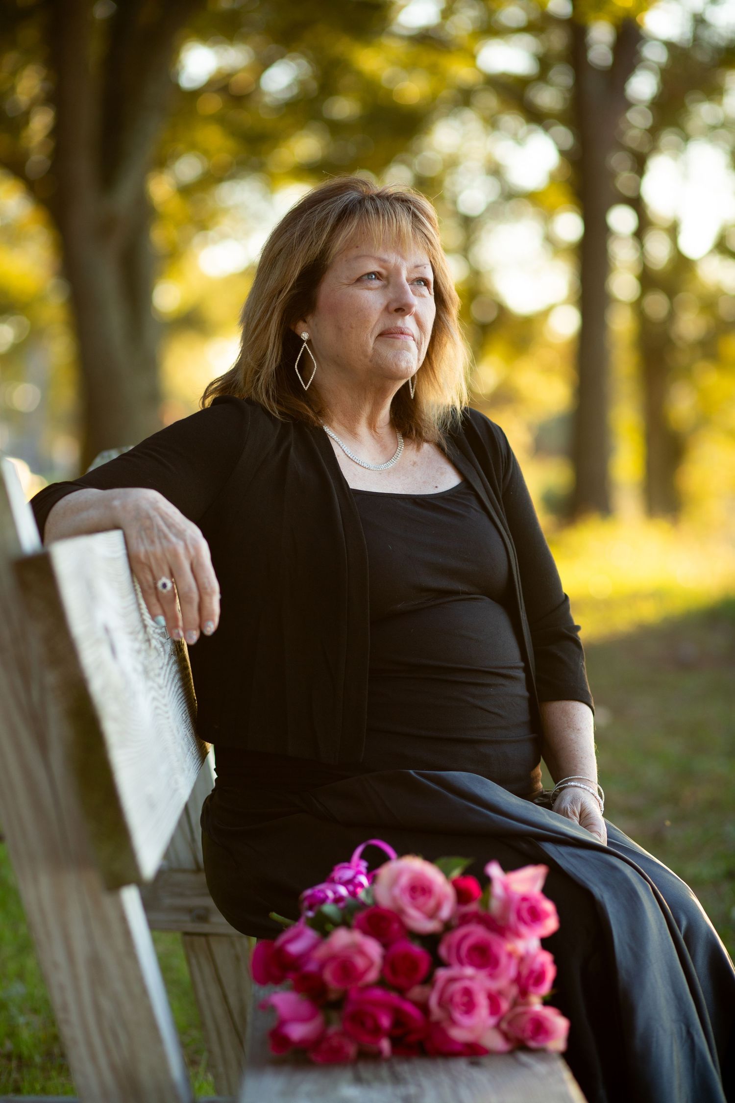 woman sitting on a bench with flowers