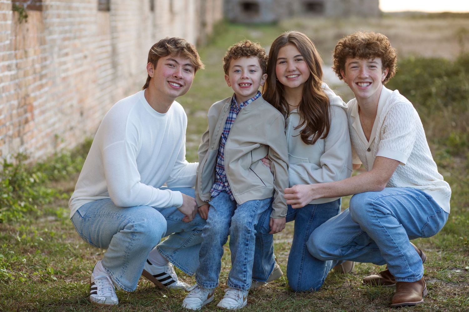 kids squatting together at Fort Pickens Pensacola Beach Florida