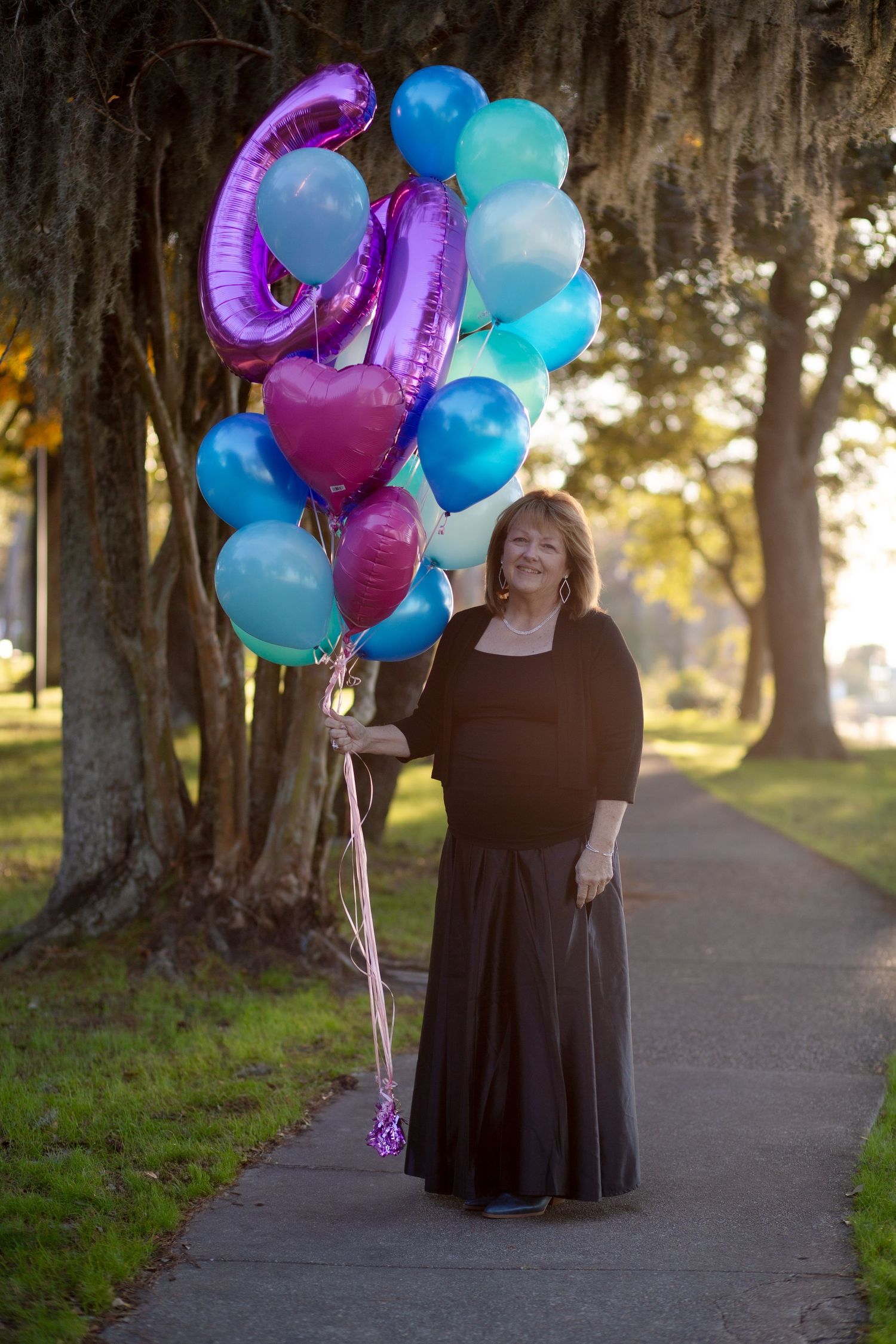 woman walking with birthday balloons