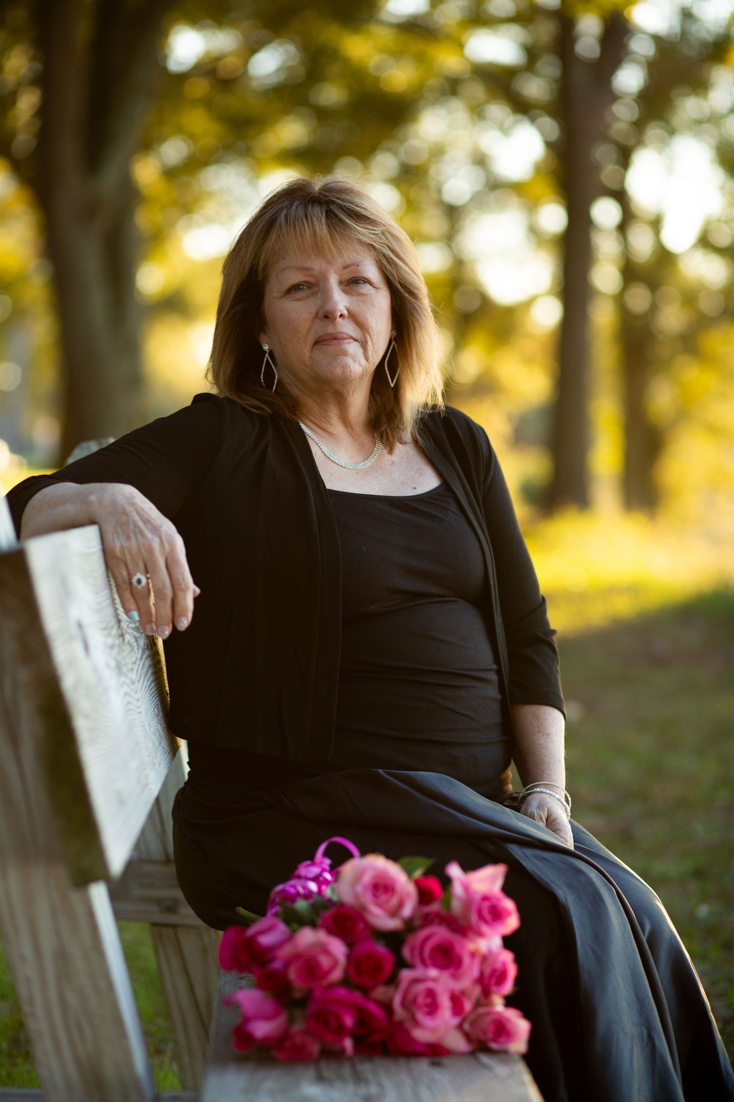 woman sitting on a bench with flowers