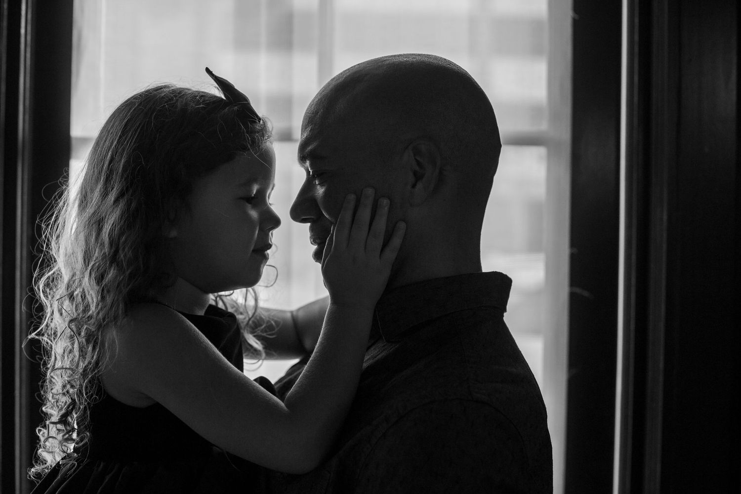 daughter holding her daddy's face
