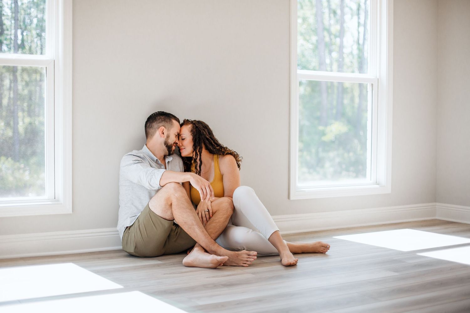couple cuddling sitting on the floor