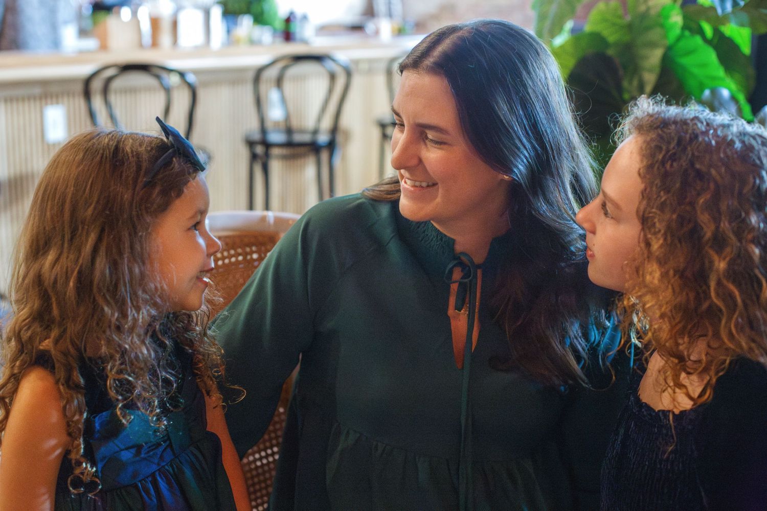 mother and daughters looking at each other