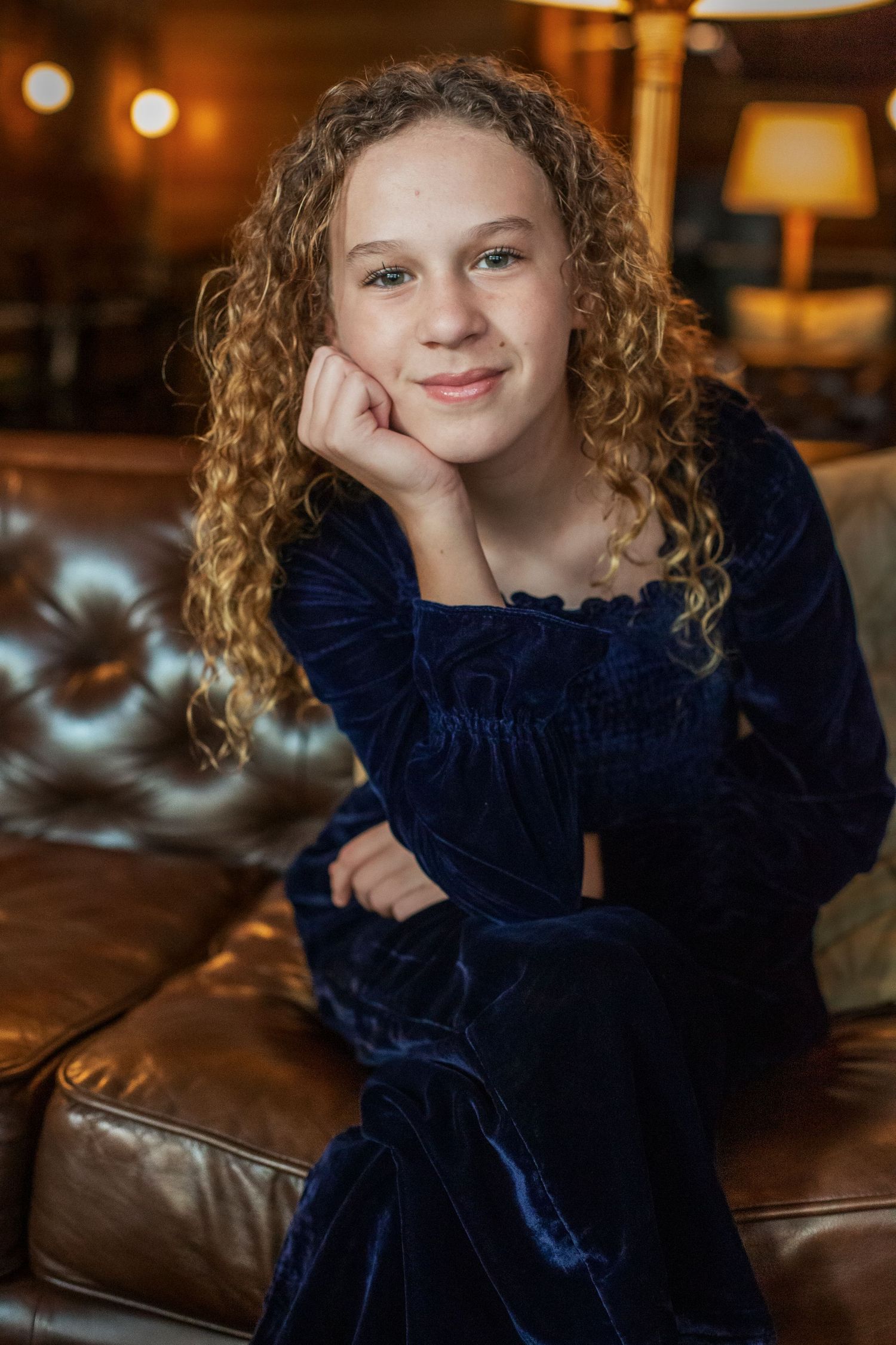 preteen girl sitting on a couch