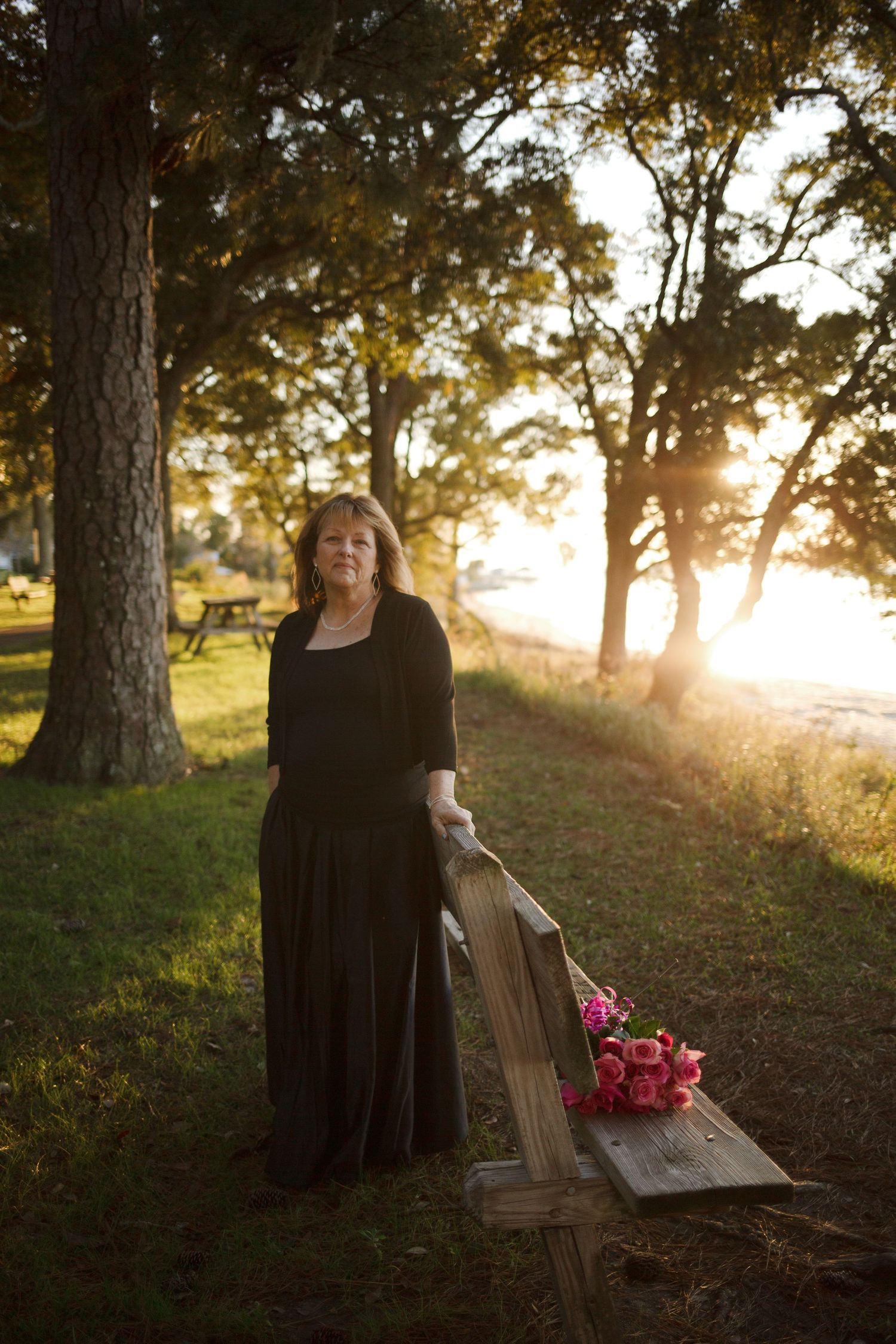 woman with flowers in sunset lighting